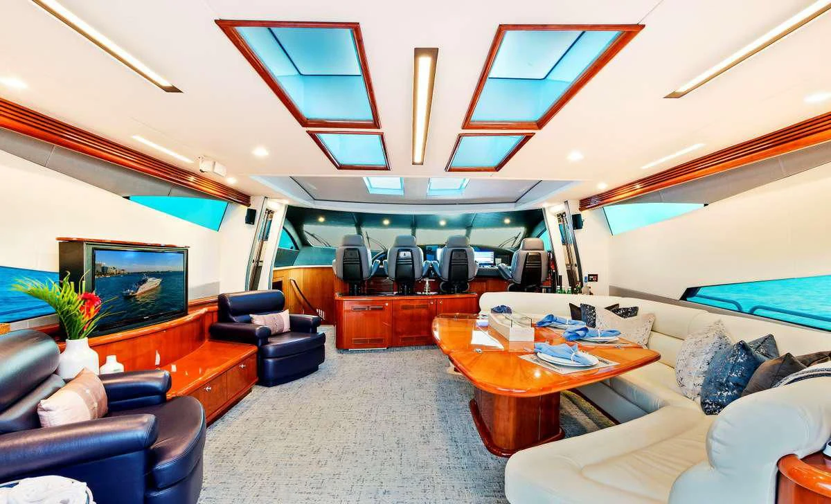 a room with a table chairs and a television aboard PRIVEE Yacht for Sale