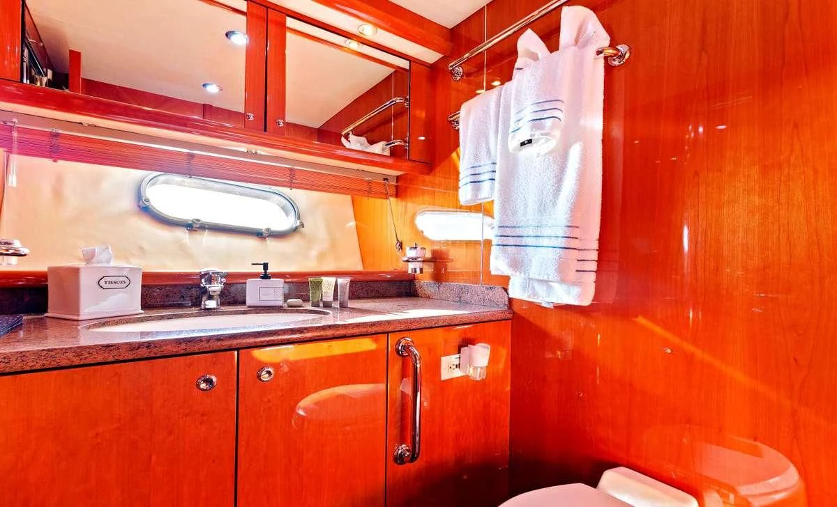 a kitchen with wooden cabinets aboard PRIVEE Yacht for Sale