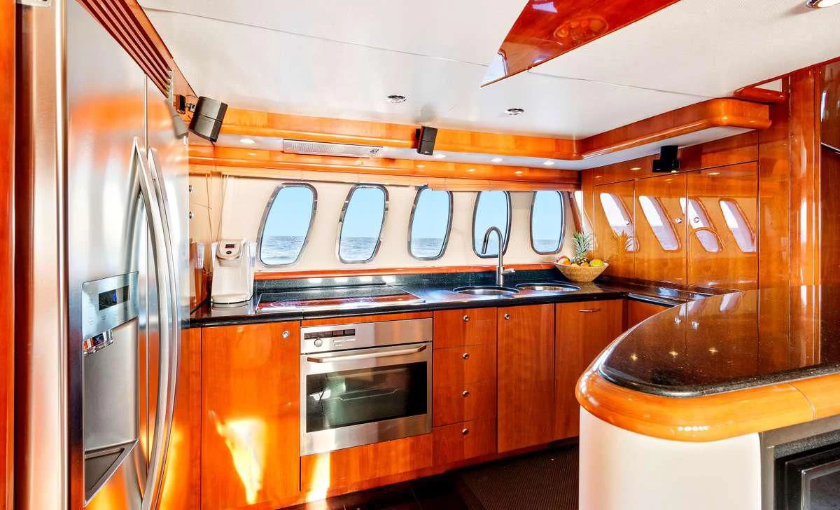a kitchen with wooden cabinets aboard PRIVEE Yacht for Sale