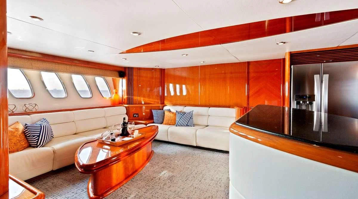 a living room with a couch and a table aboard PRIVEE Yacht for Sale