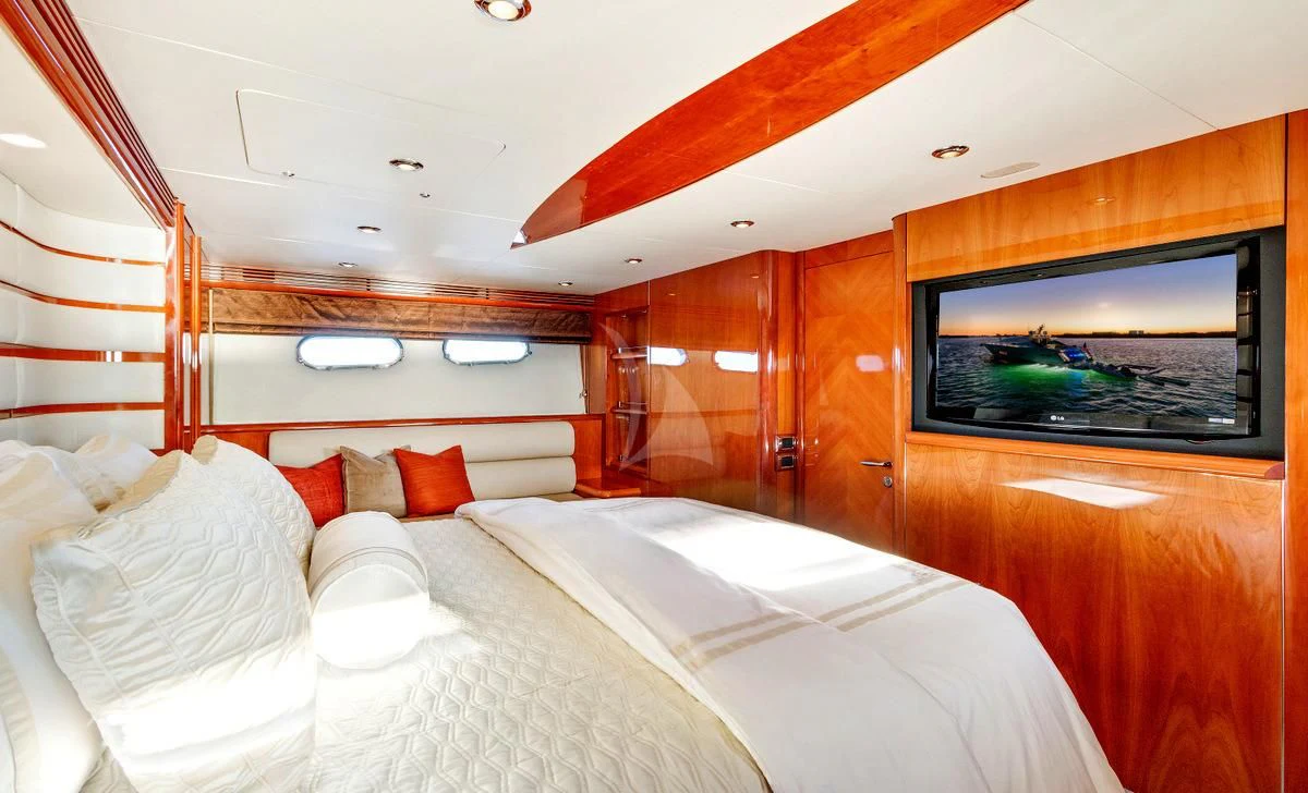 a room with a bed and a television aboard PRIVEE Yacht for Sale