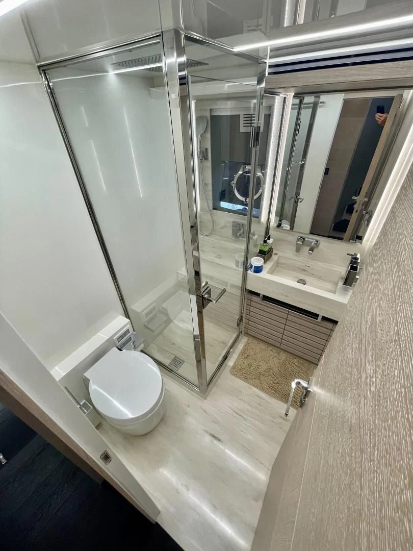 a bathroom with a glass shower aboard AGRODOLCE Yacht for Sale