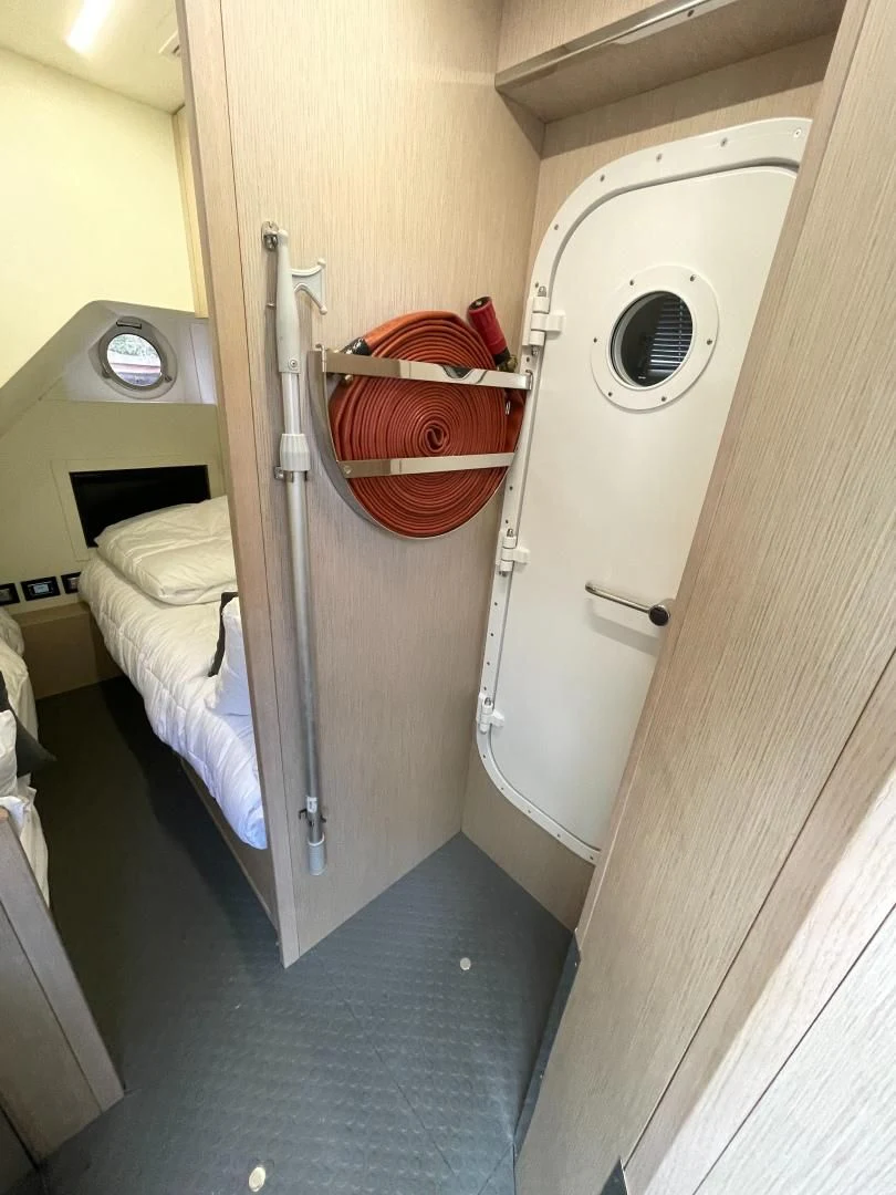 a room with a bed and a chair aboard AGRODOLCE Yacht for Sale