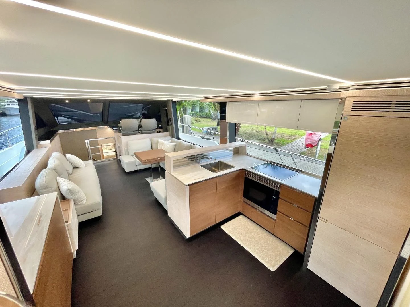 a room with a large window and a table with chairs aboard AGRODOLCE Yacht for Sale