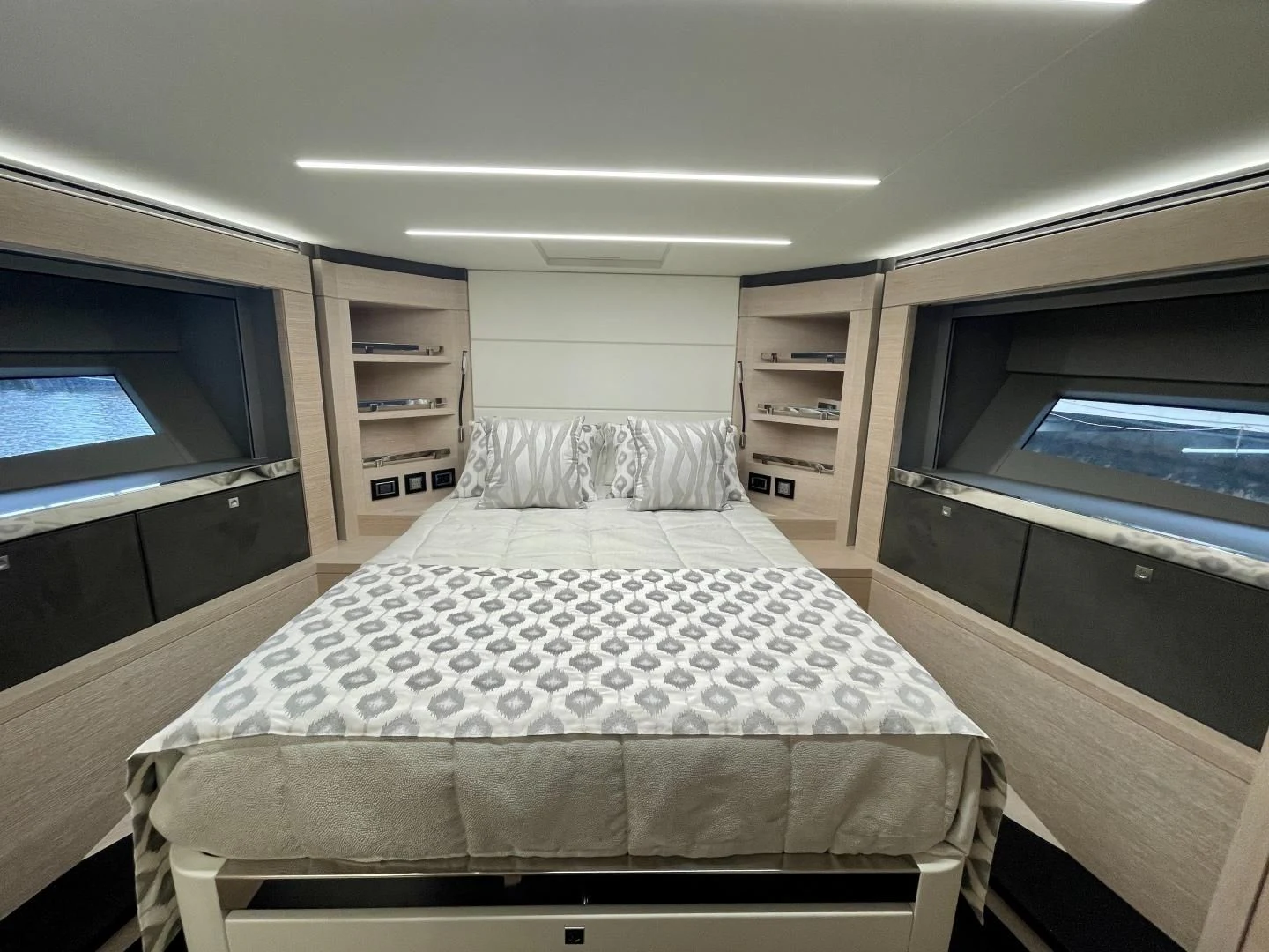 a bedroom with a bed and a bookcase aboard AGRODOLCE Yacht for Sale