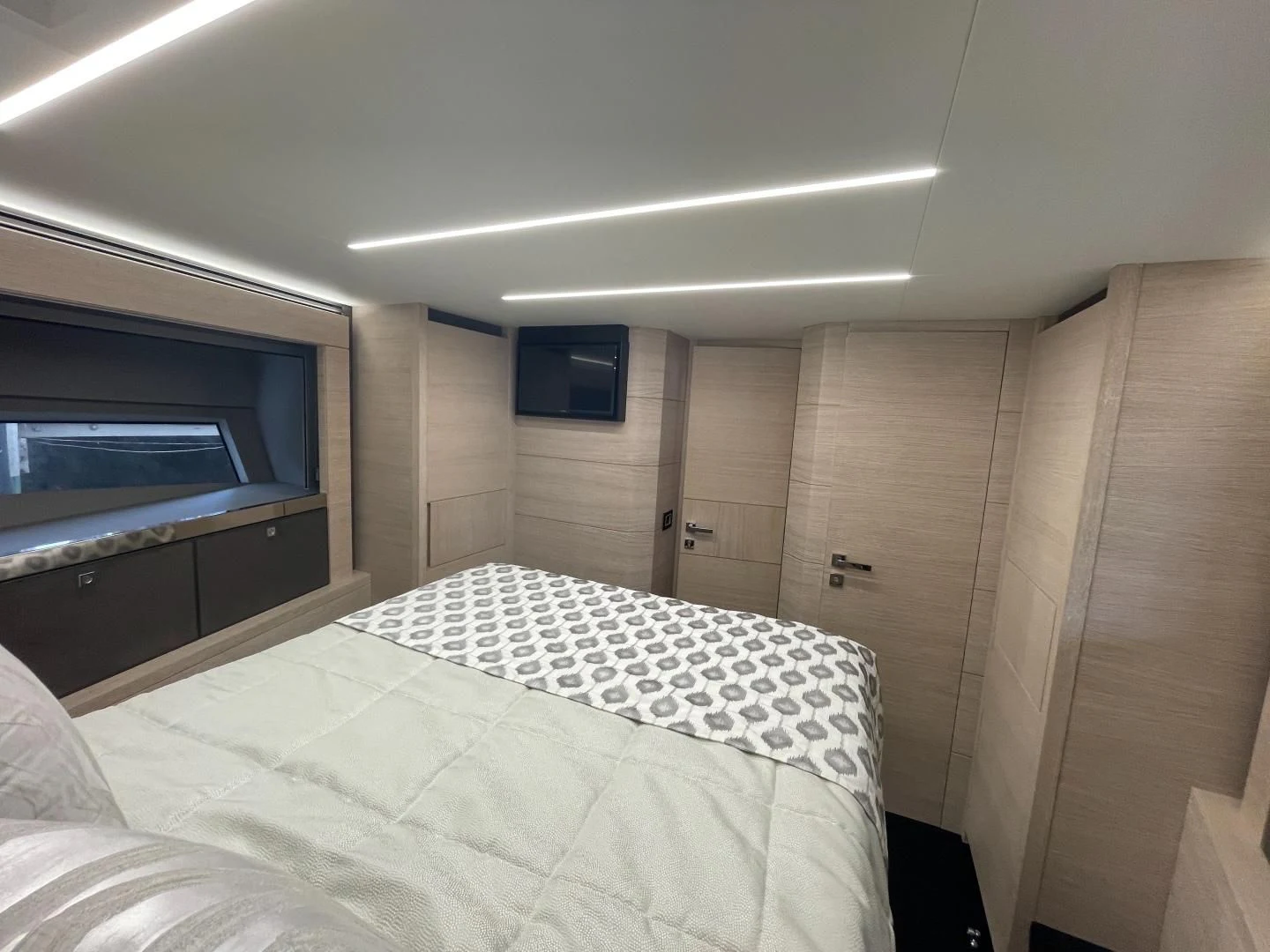 a room with a bed and a television aboard AGRODOLCE Yacht for Sale