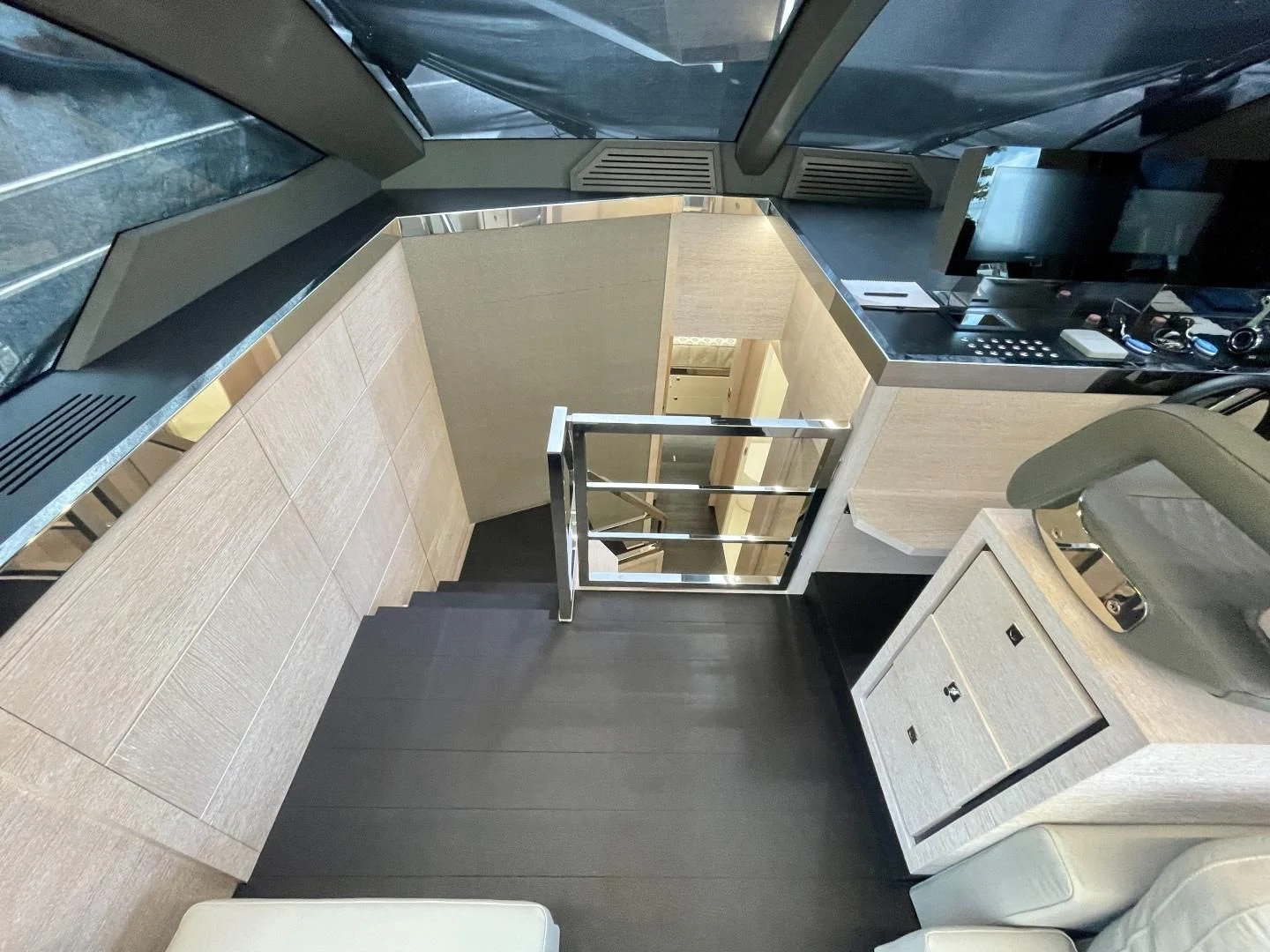 a room with a desk and a shelf with computer monitors aboard AGRODOLCE Yacht for Sale