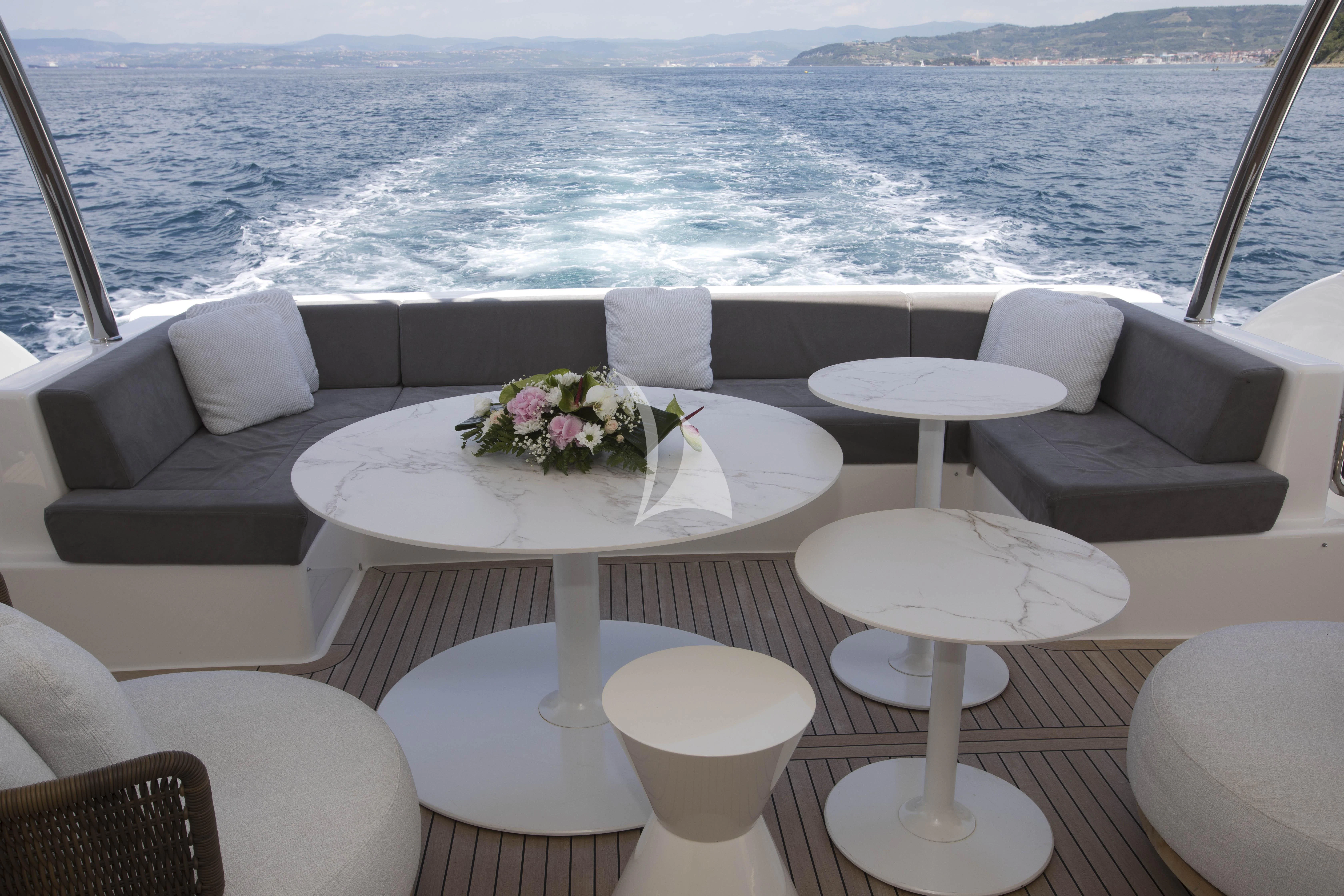 a table with chairs on it aboard DAMARI Yacht for Charter
