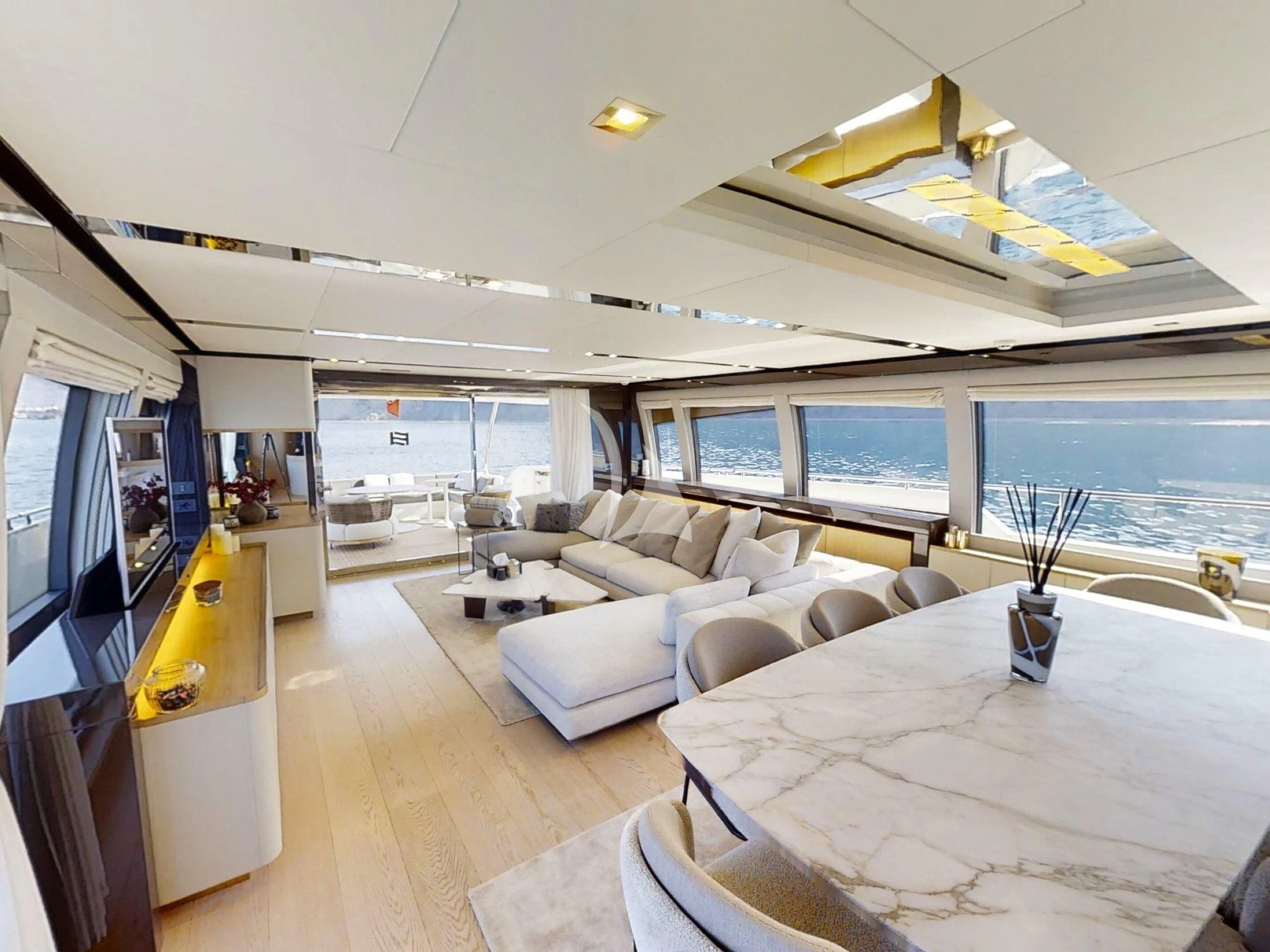a room with a large bed and a large window aboard DAMARI Yacht for Charter