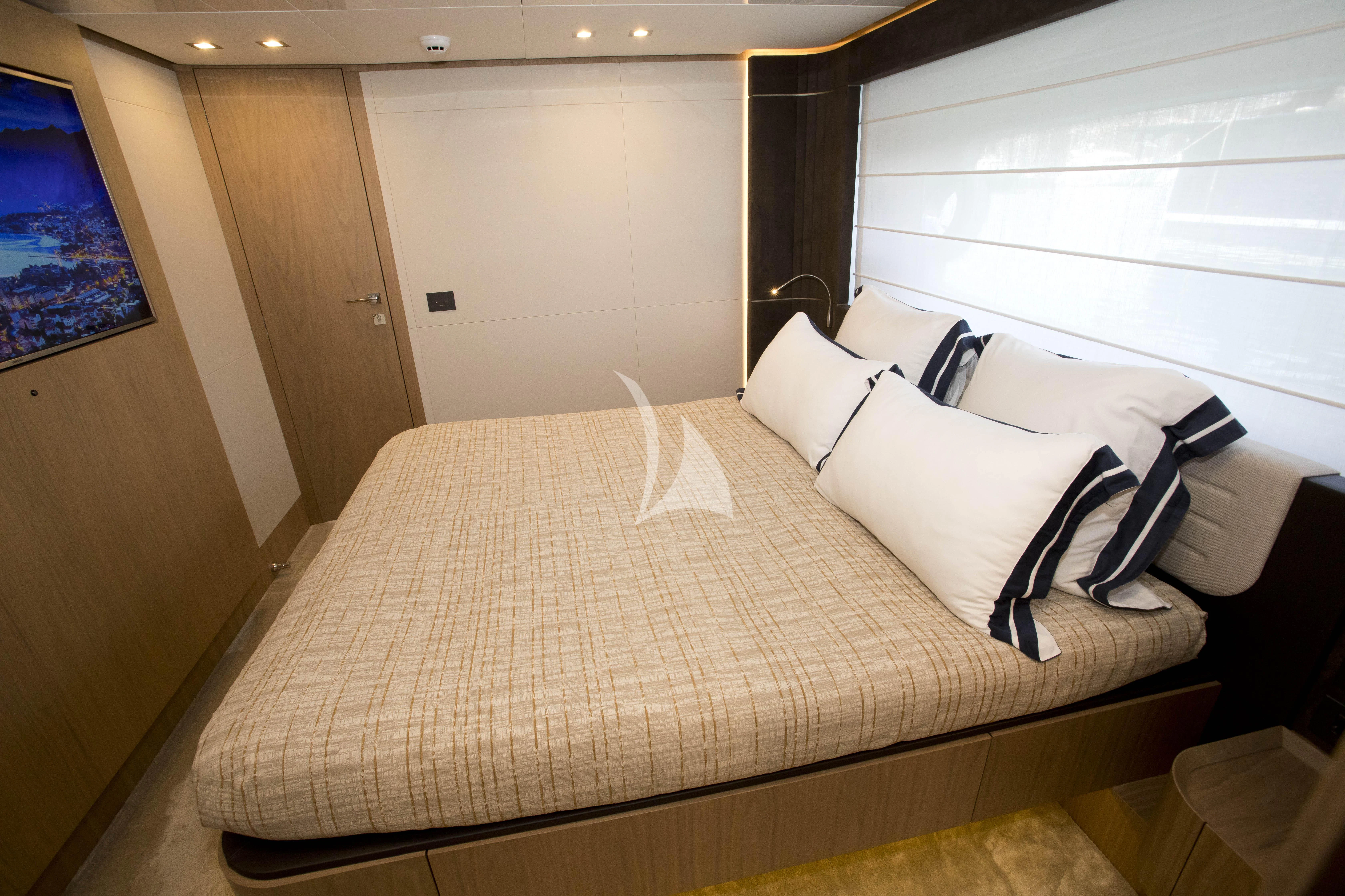 a bed with white pillows aboard DAMARI Yacht for Charter