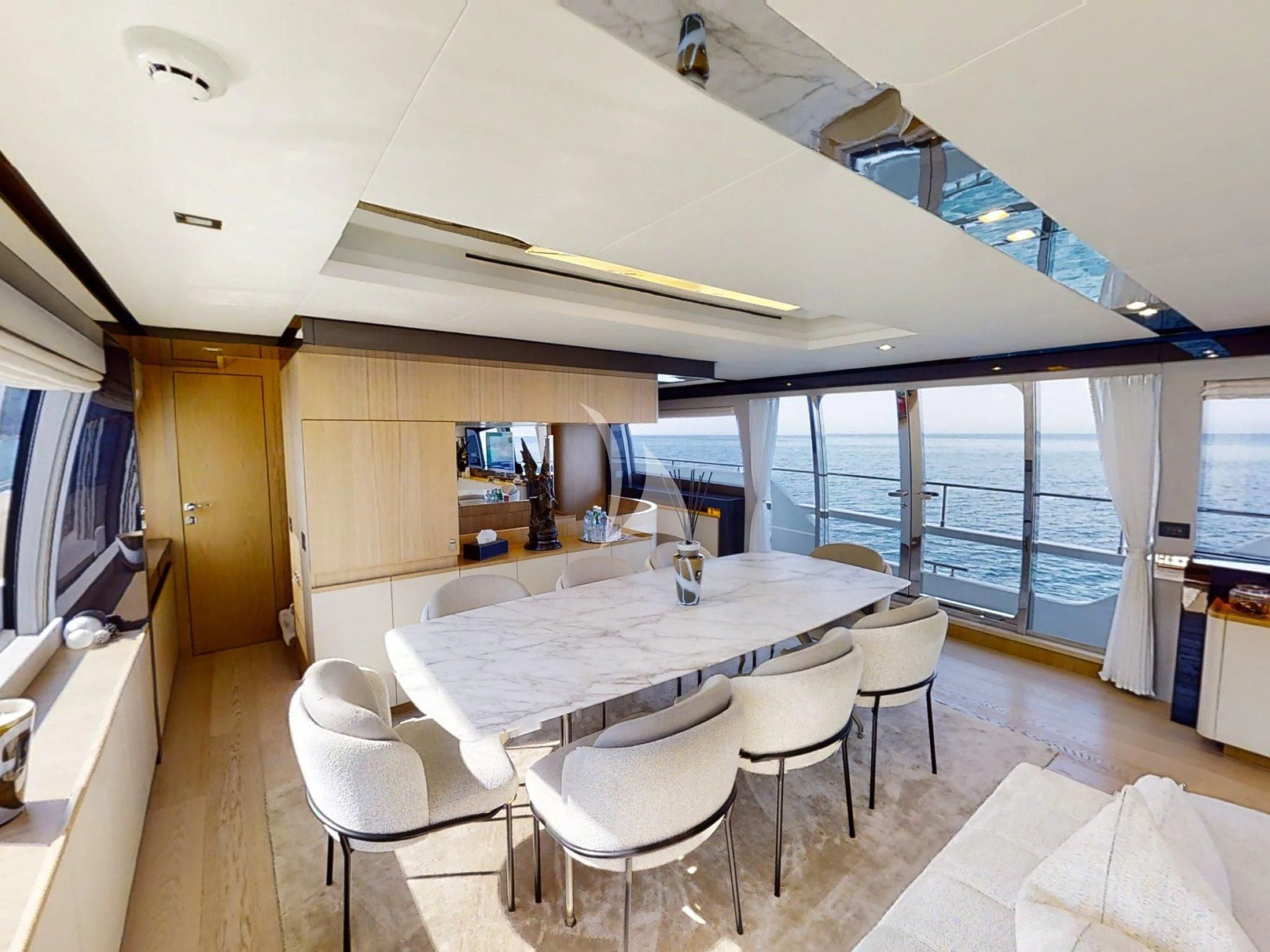 a room with a table and chairs aboard DAMARI Yacht for Charter