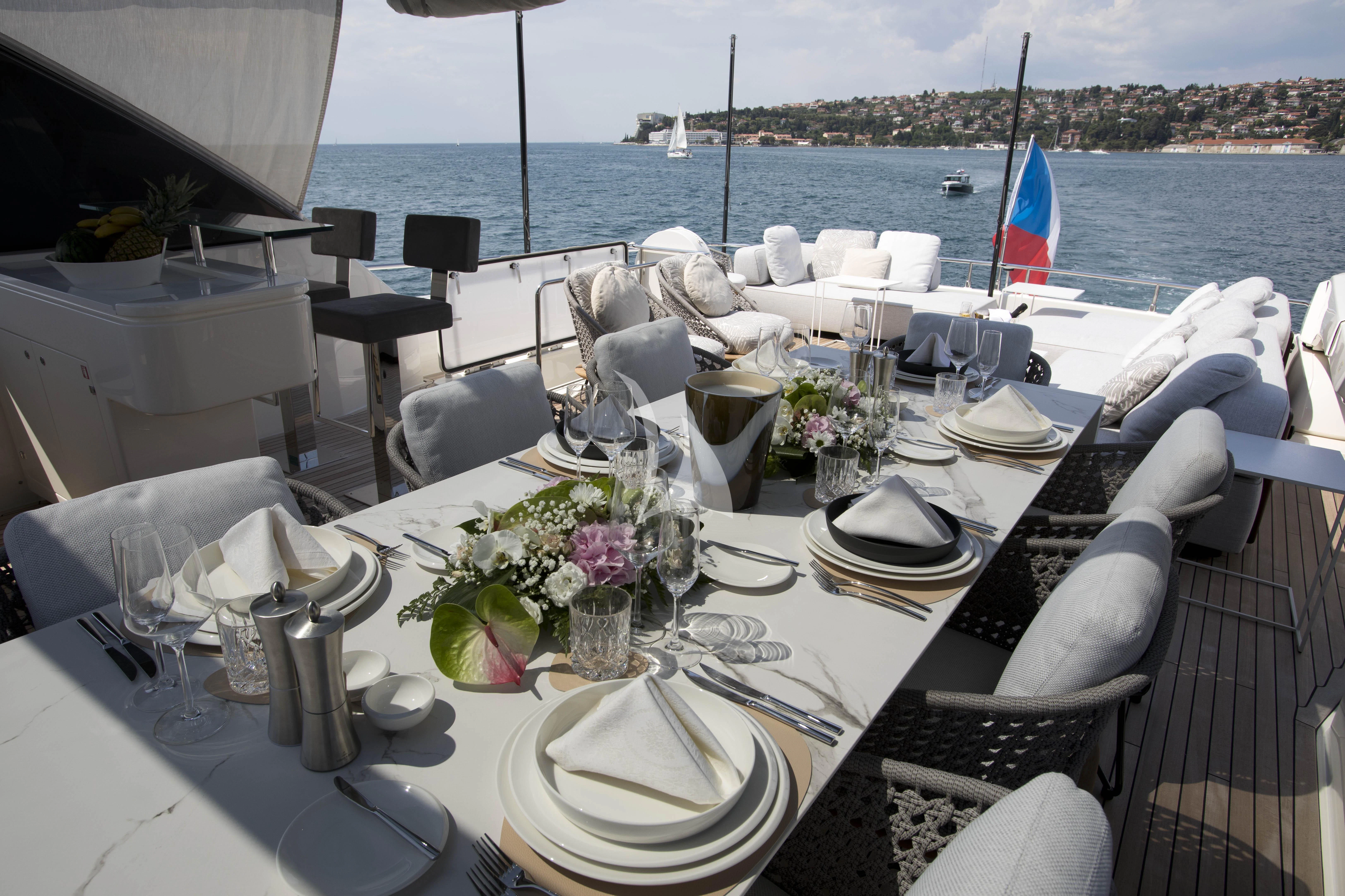 a table set with place settings aboard DAMARI Yacht for Charter
