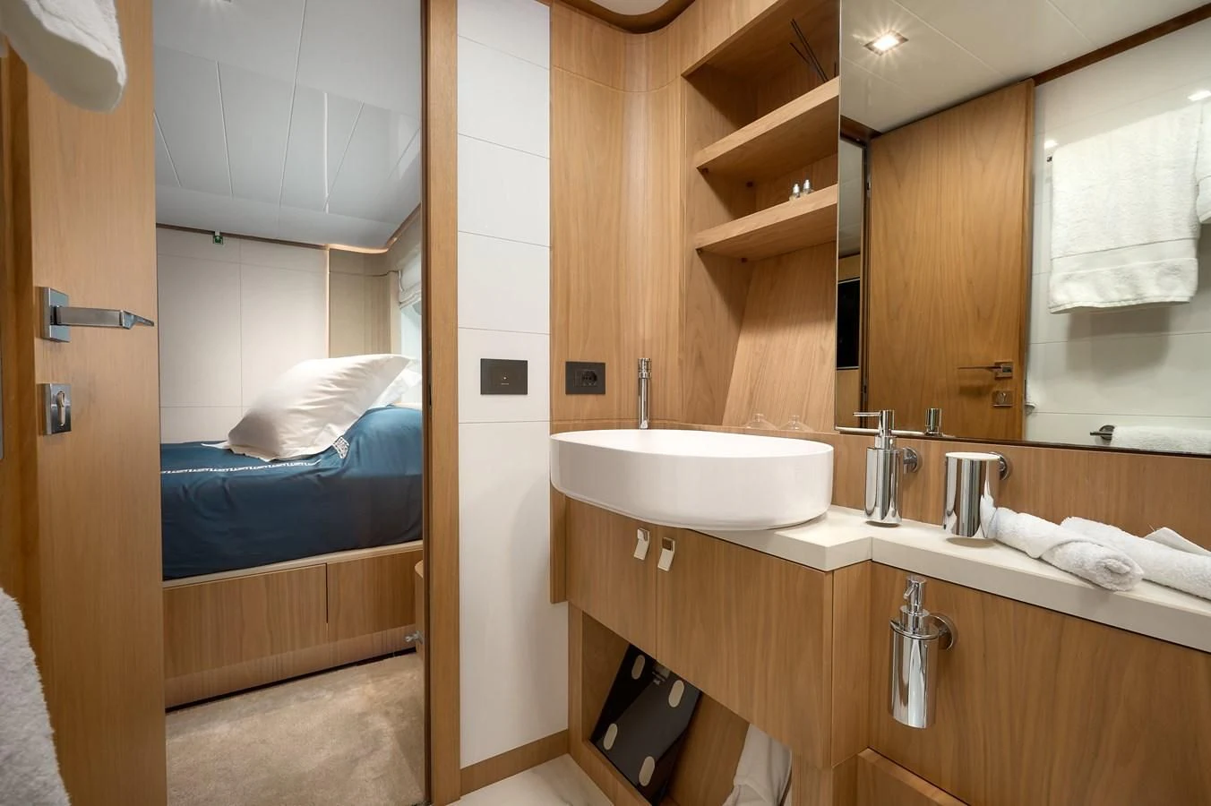 a bathroom with a bed sink and a mirror aboard DAMARI Yacht for Charter
