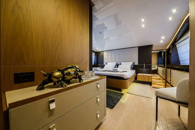 a bedroom with a bed and a desk aboard DAMARI Yacht for Charter
