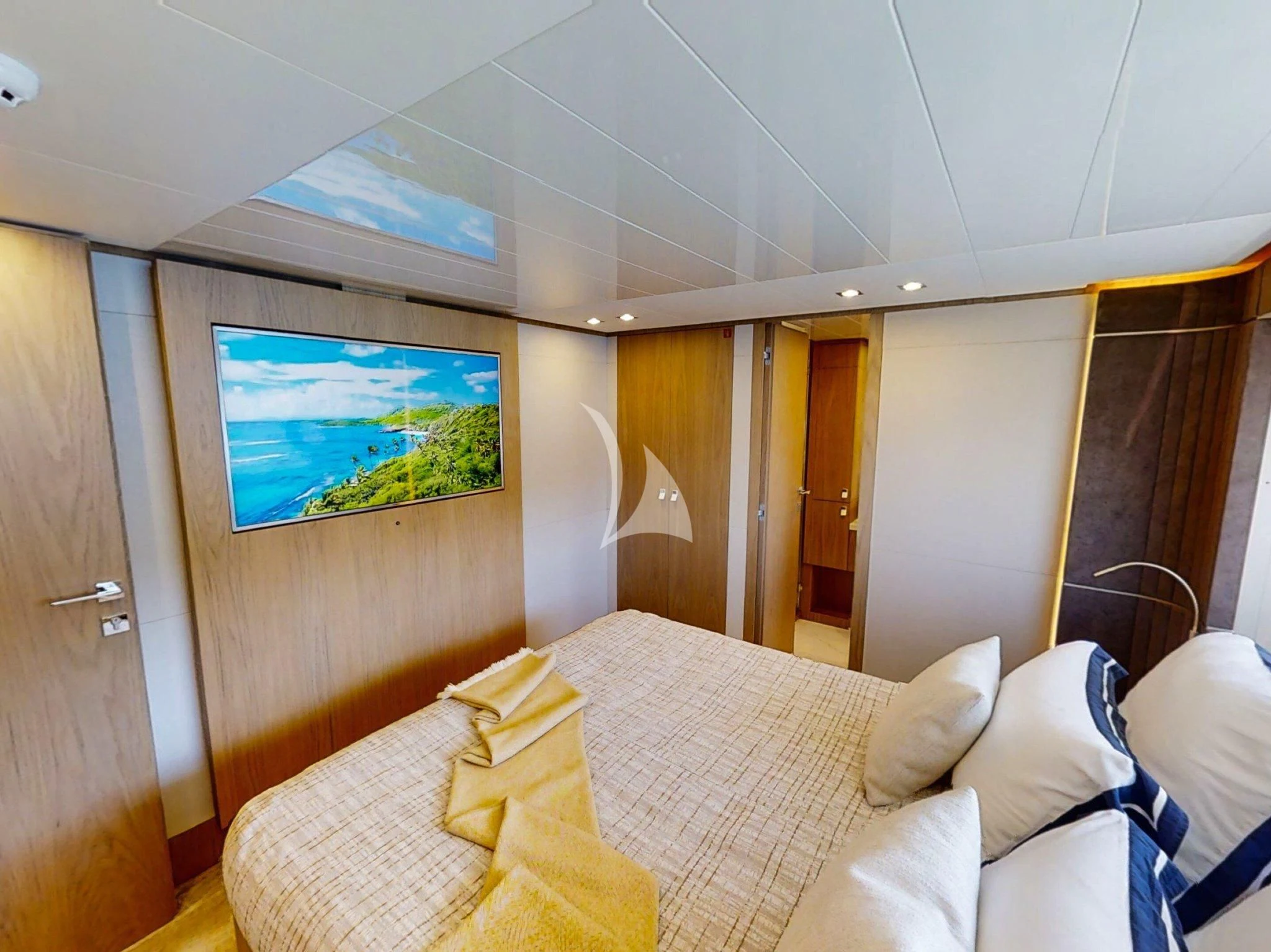 a room with a bed and a tv on the wall aboard DAMARI Yacht for Charter