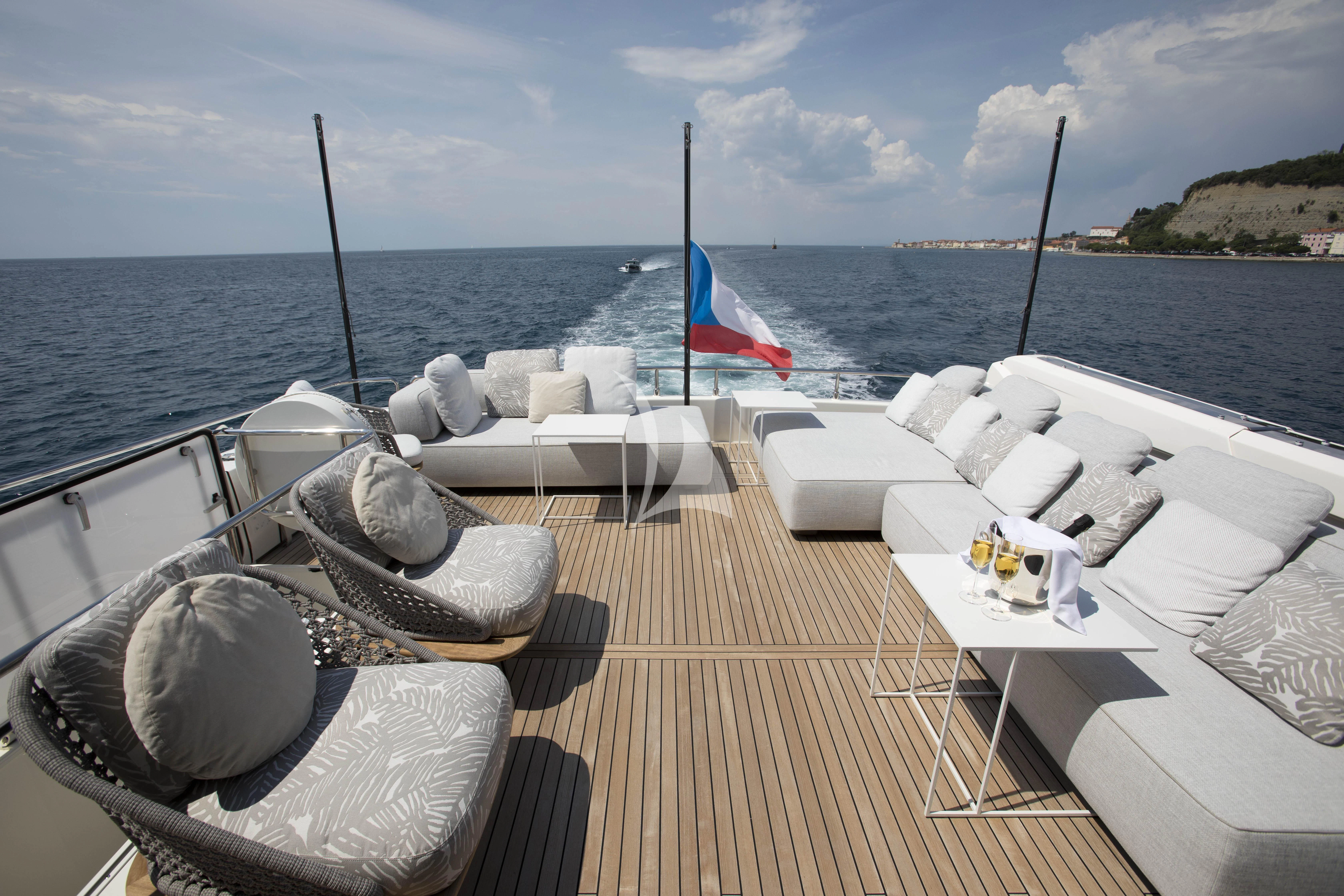 a boat with a flag on the deck aboard DAMARI Yacht for Charter