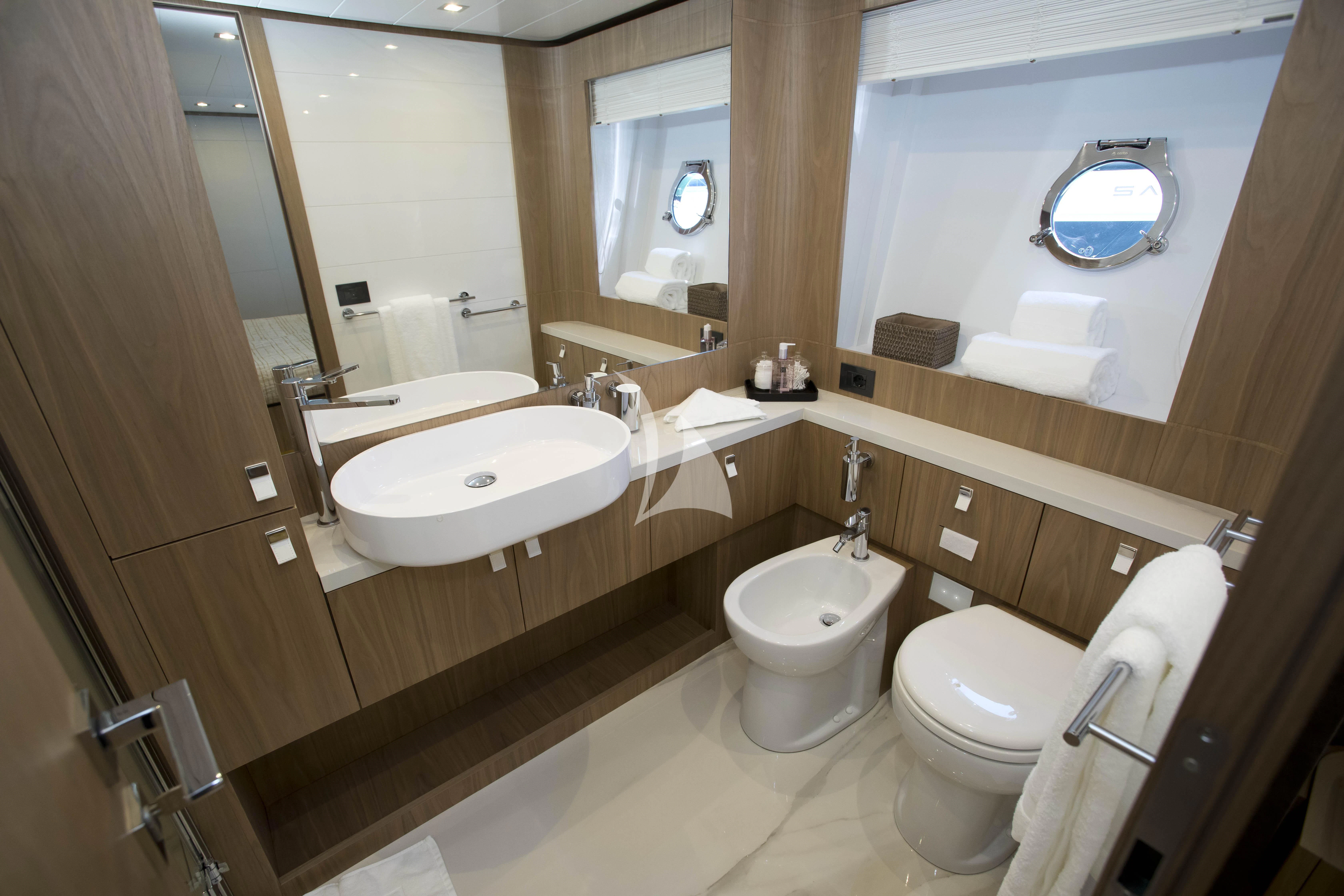 a bathroom with a tub toilet and sink aboard DAMARI Yacht for Charter