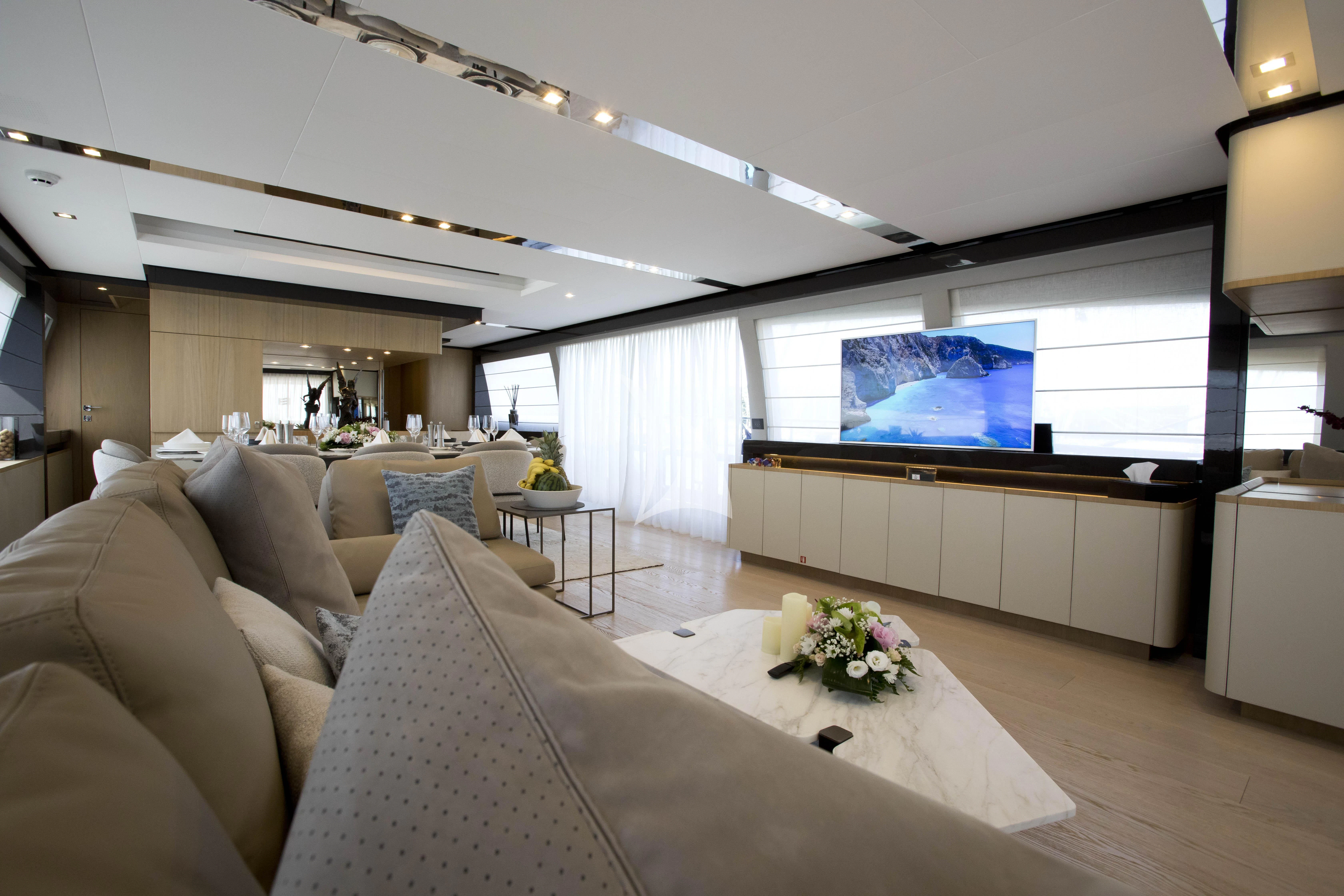 a living room with a large screen aboard DAMARI Yacht for Charter