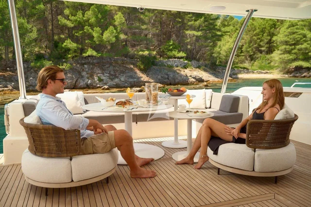 a couple of women sitting at a table outside aboard DAMARI Yacht for Charter