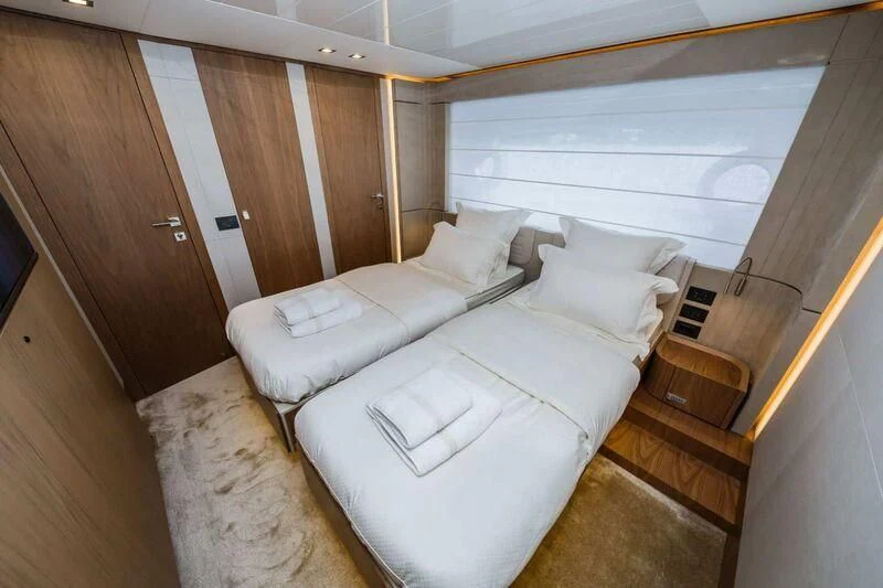 a room with a bed and a window aboard DAMARI Yacht for Charter