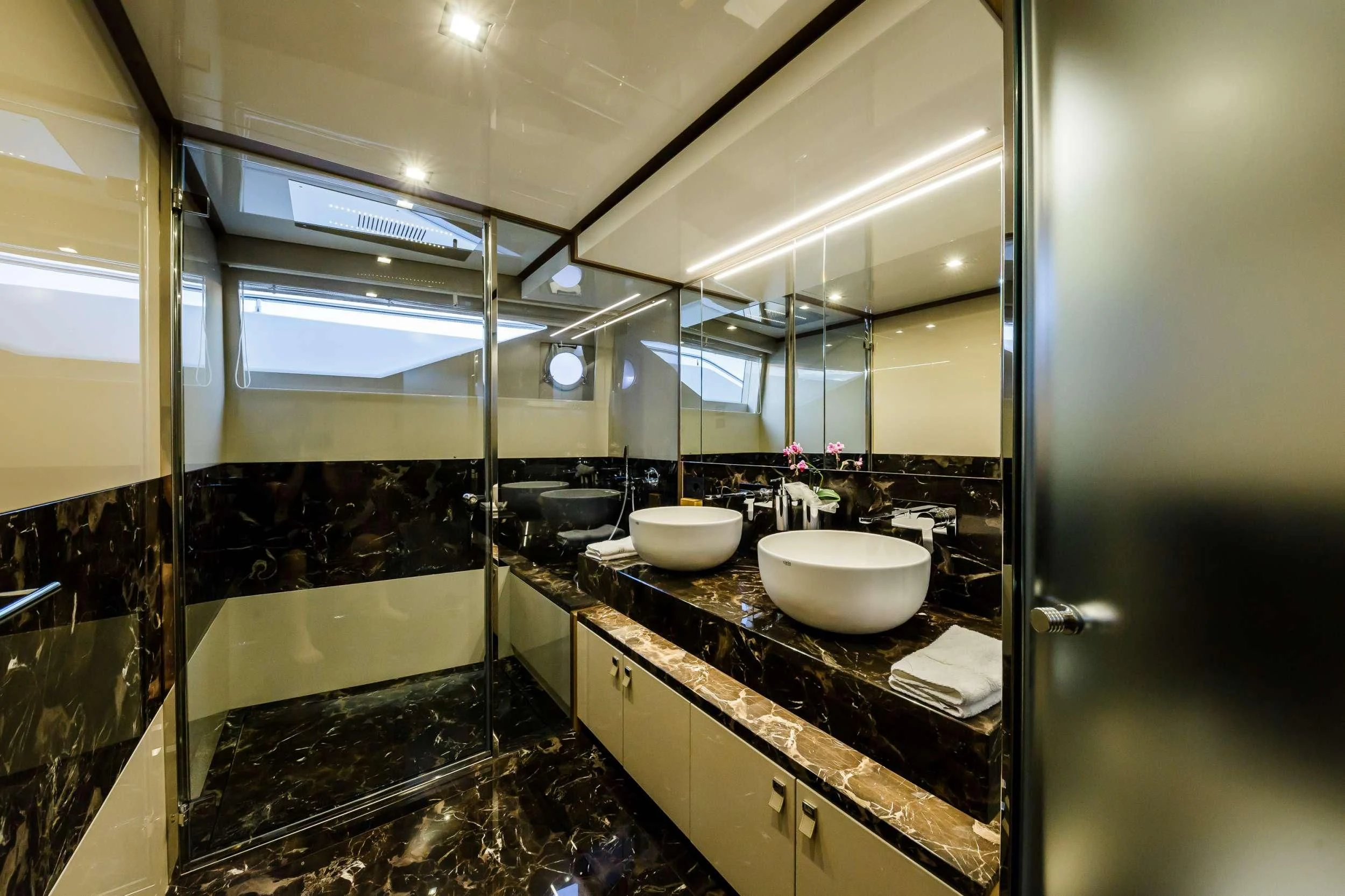 a bathroom with sinks and mirrors aboard DAMARI Yacht for Charter