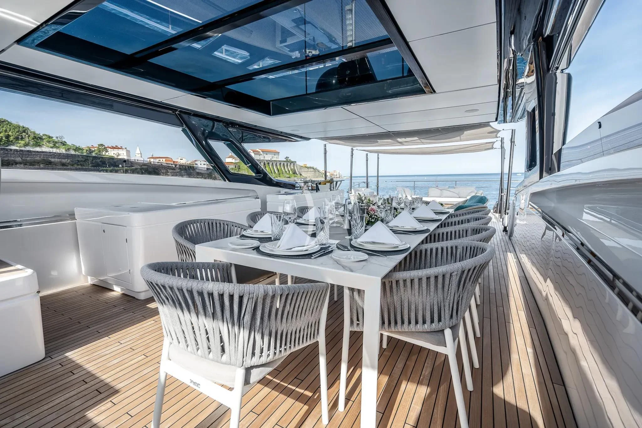 a table and chairs on a deck aboard DAMARI Yacht for Charter
