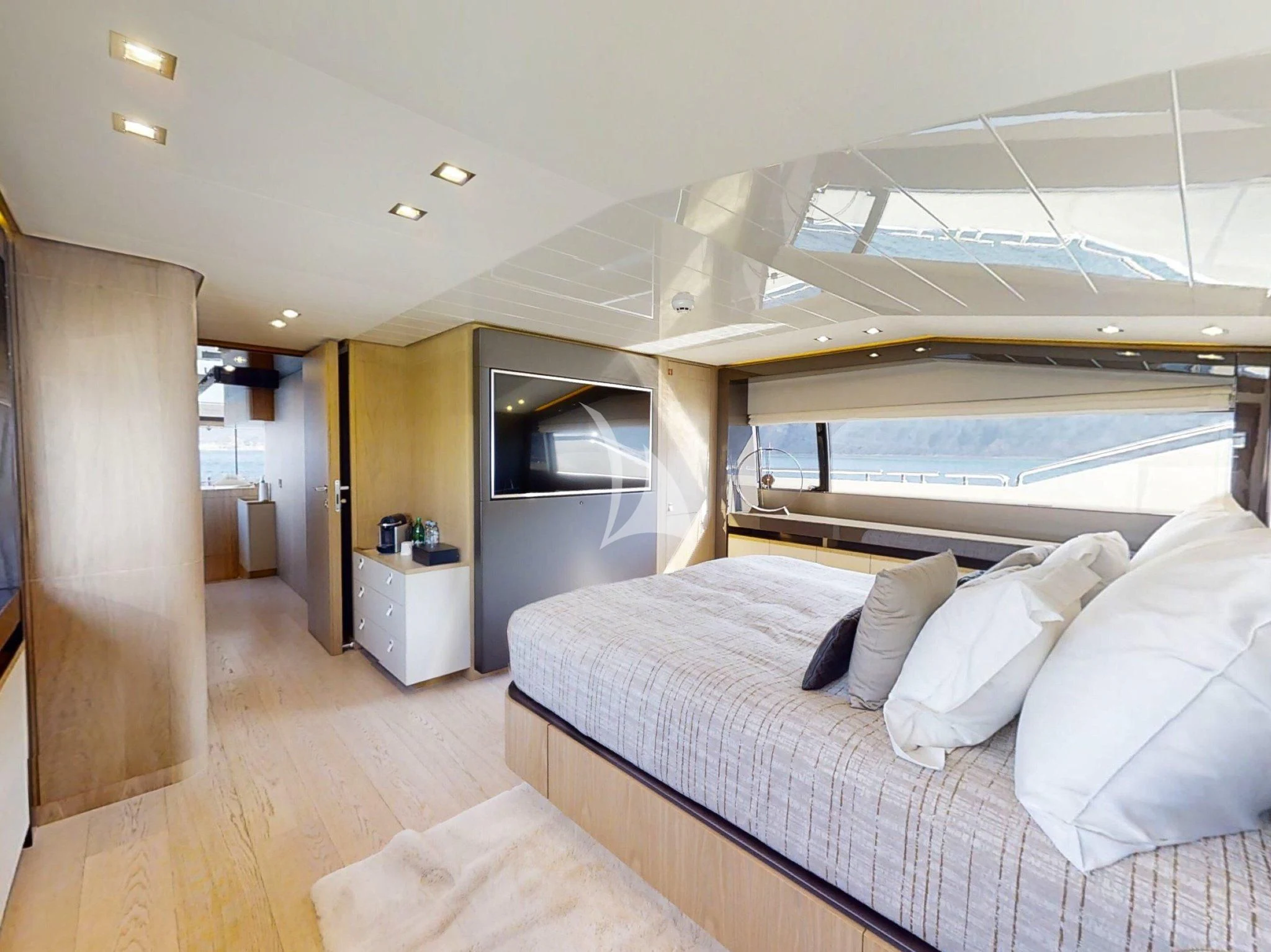 a room with a bed and a television aboard DAMARI Yacht for Charter