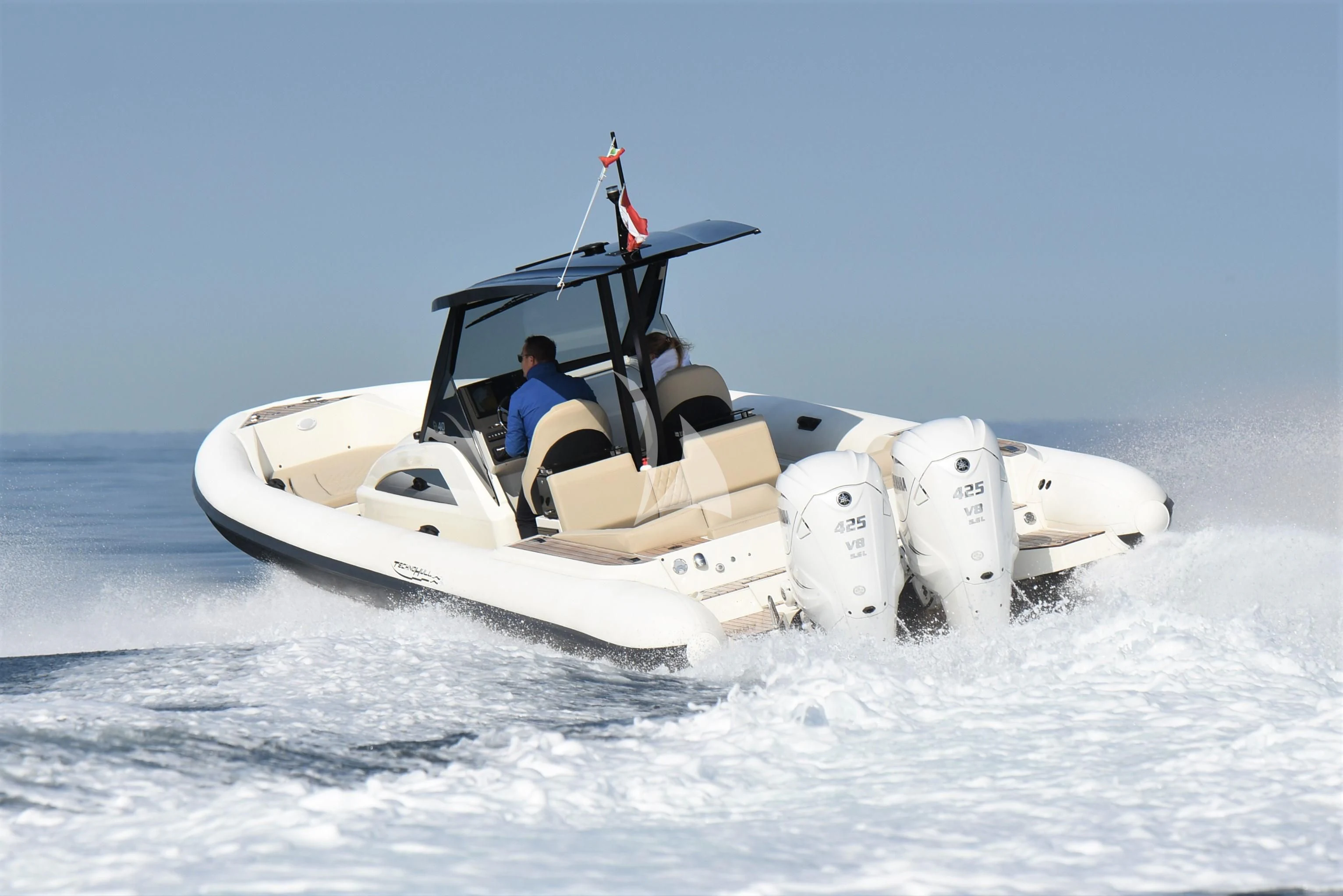 a person driving a boat aboard DAMARI Yacht for Charter