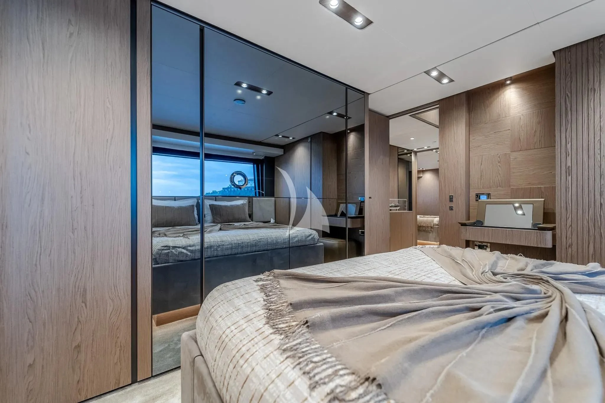 a bedroom with a bed and a large window aboard DAMARI Yacht for Charter