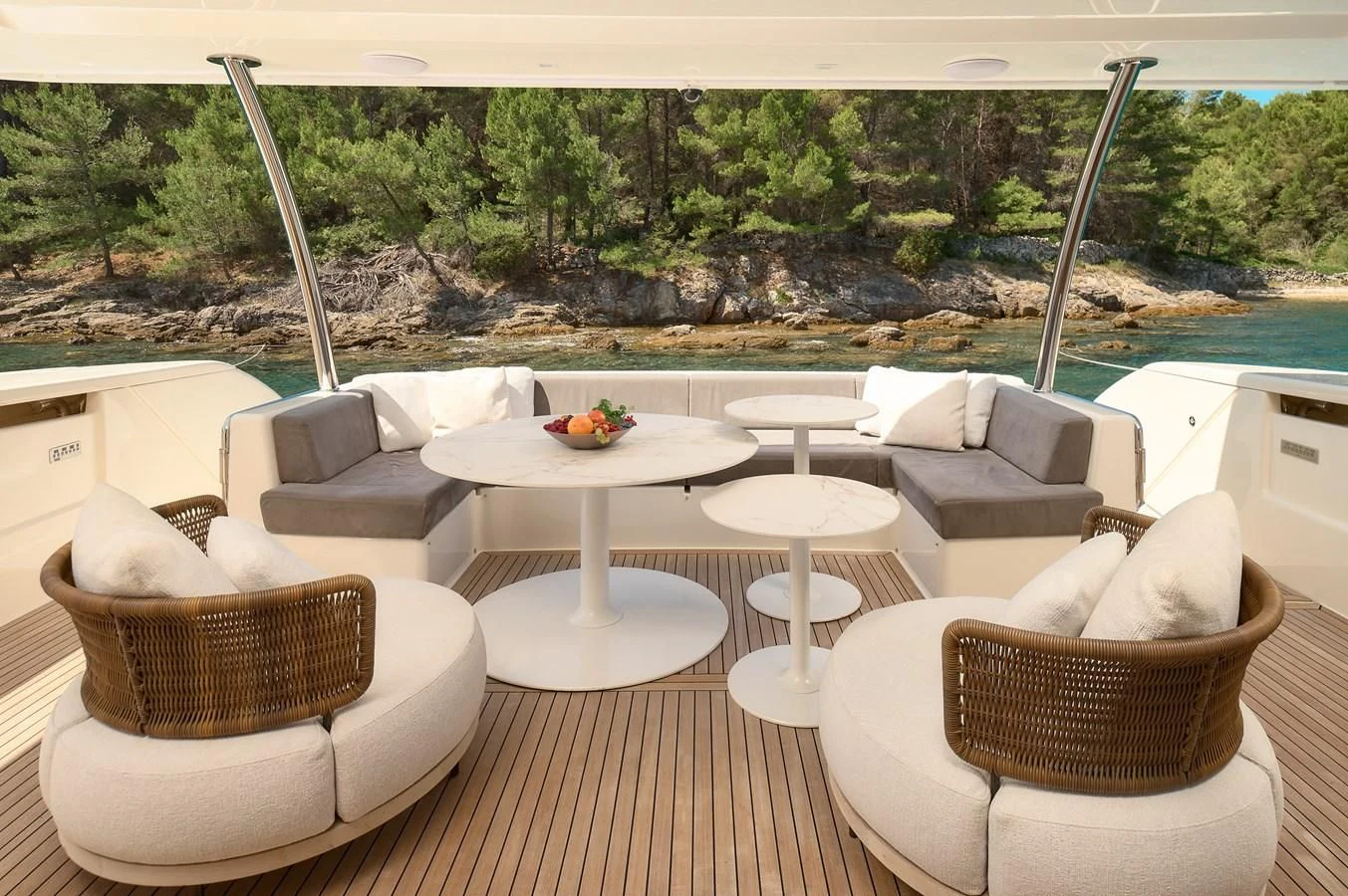 a room with a table chairs and a view of a city aboard DAMARI Yacht for Charter