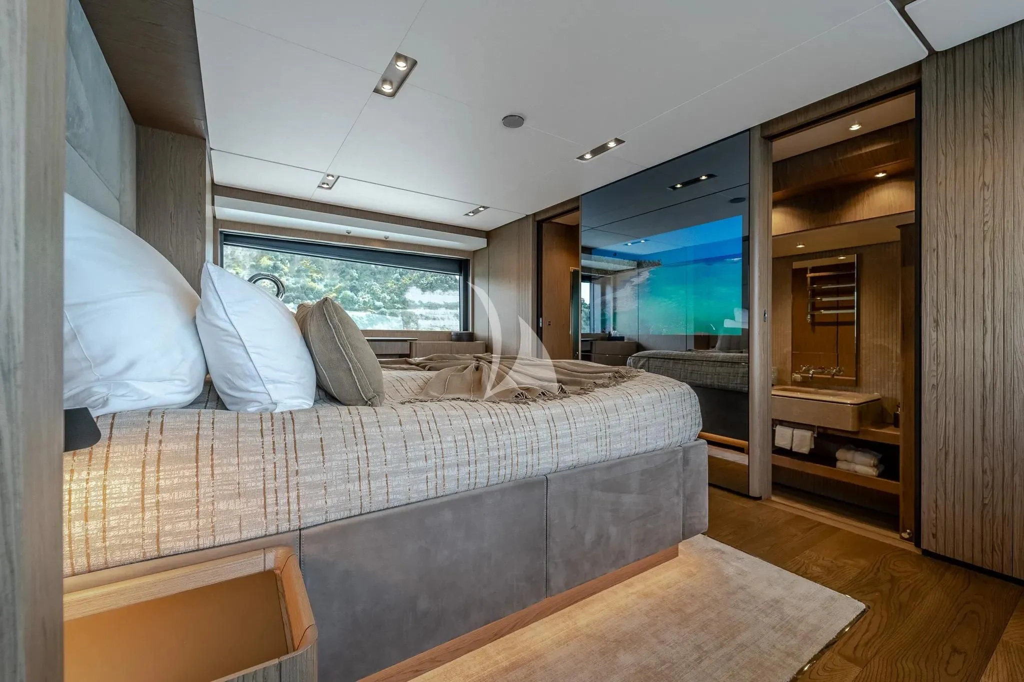 a bedroom with a bed and a wood floor aboard DAMARI Yacht for Charter