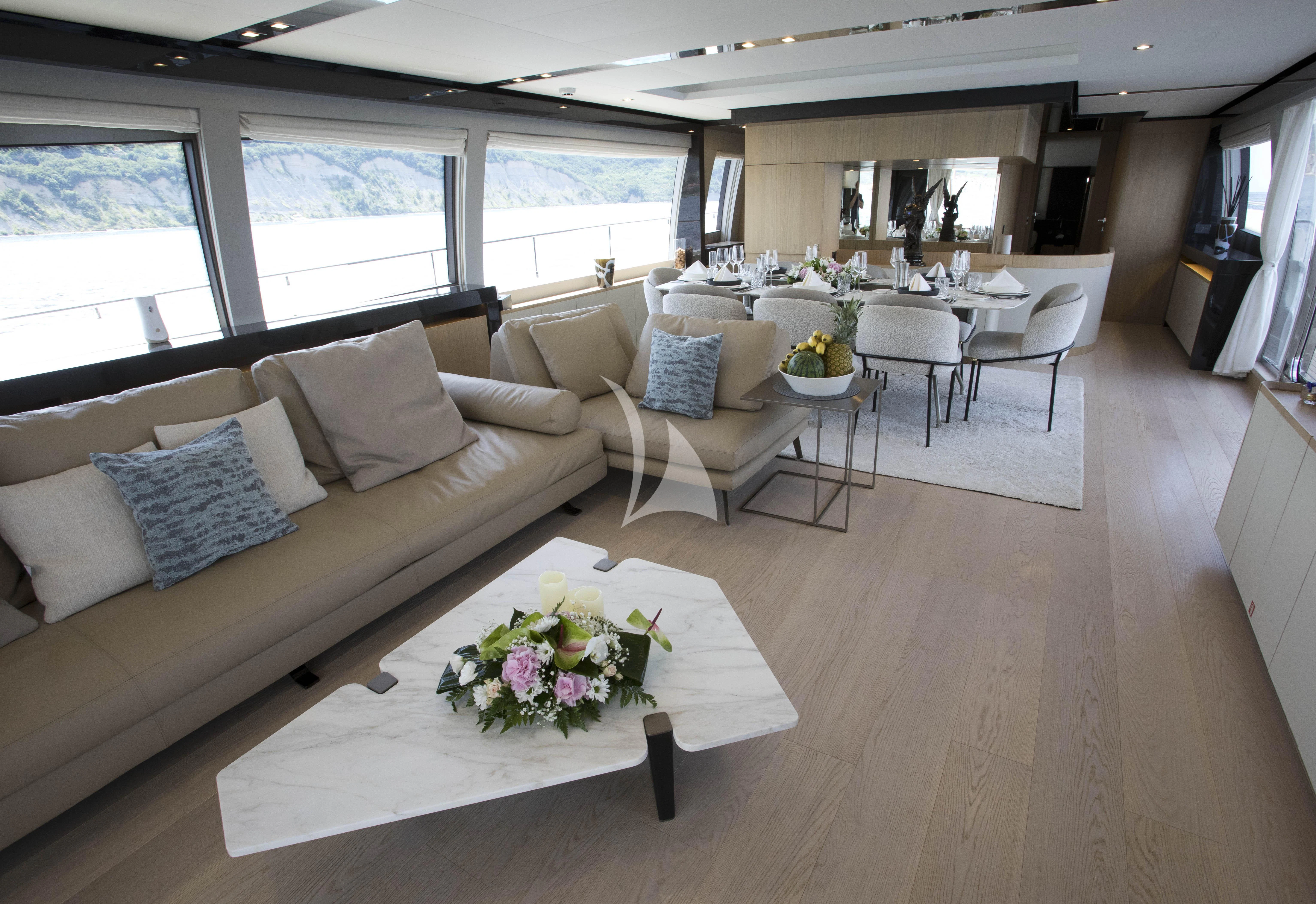 a living room with a couch and a table aboard DAMARI Yacht for Charter