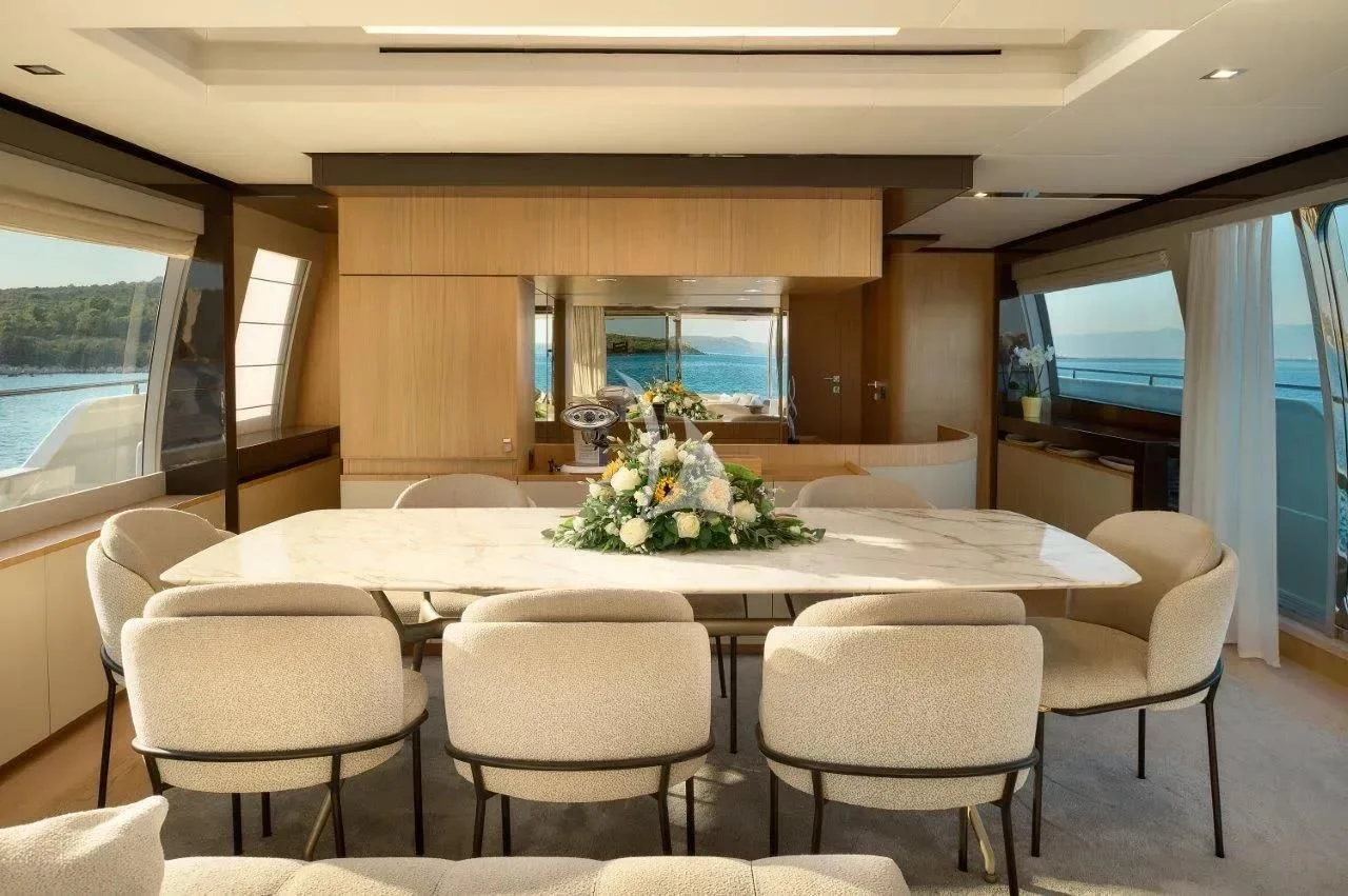 a large room with a table and chairs aboard DAMARI Yacht for Charter