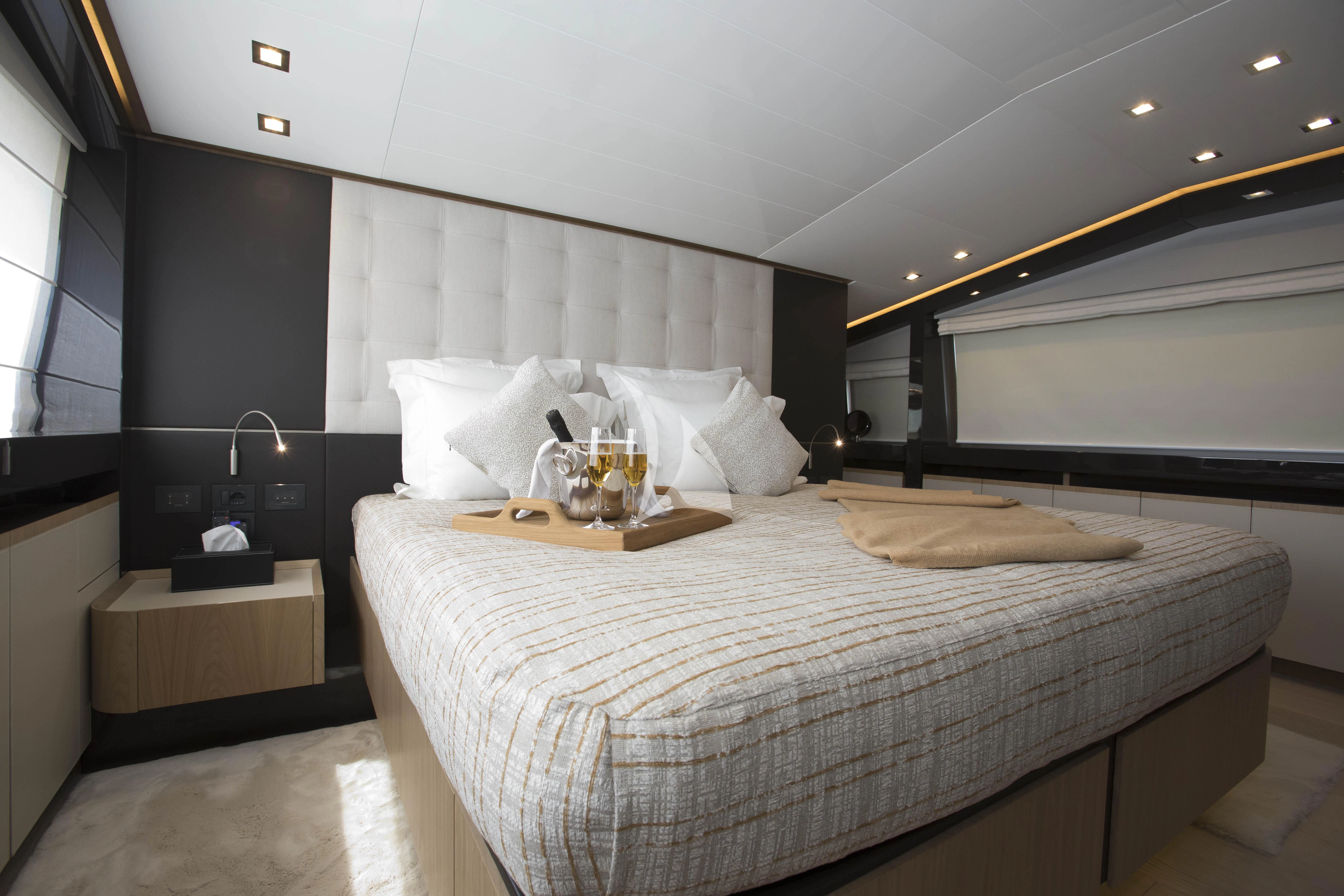 a bed with white sheets aboard DAMARI Yacht for Charter