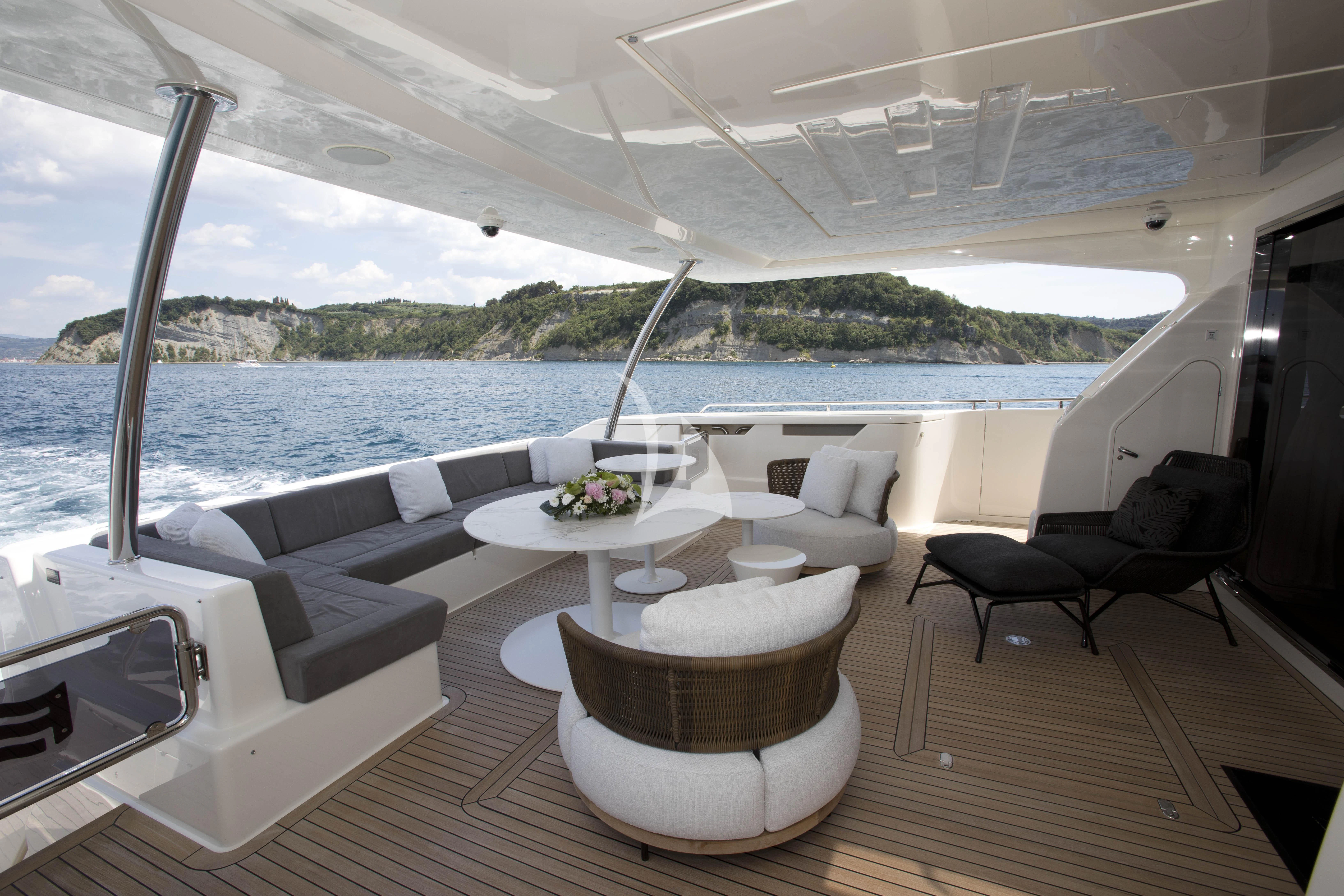 a room with a table chairs and a view of the water aboard DAMARI Yacht for Charter