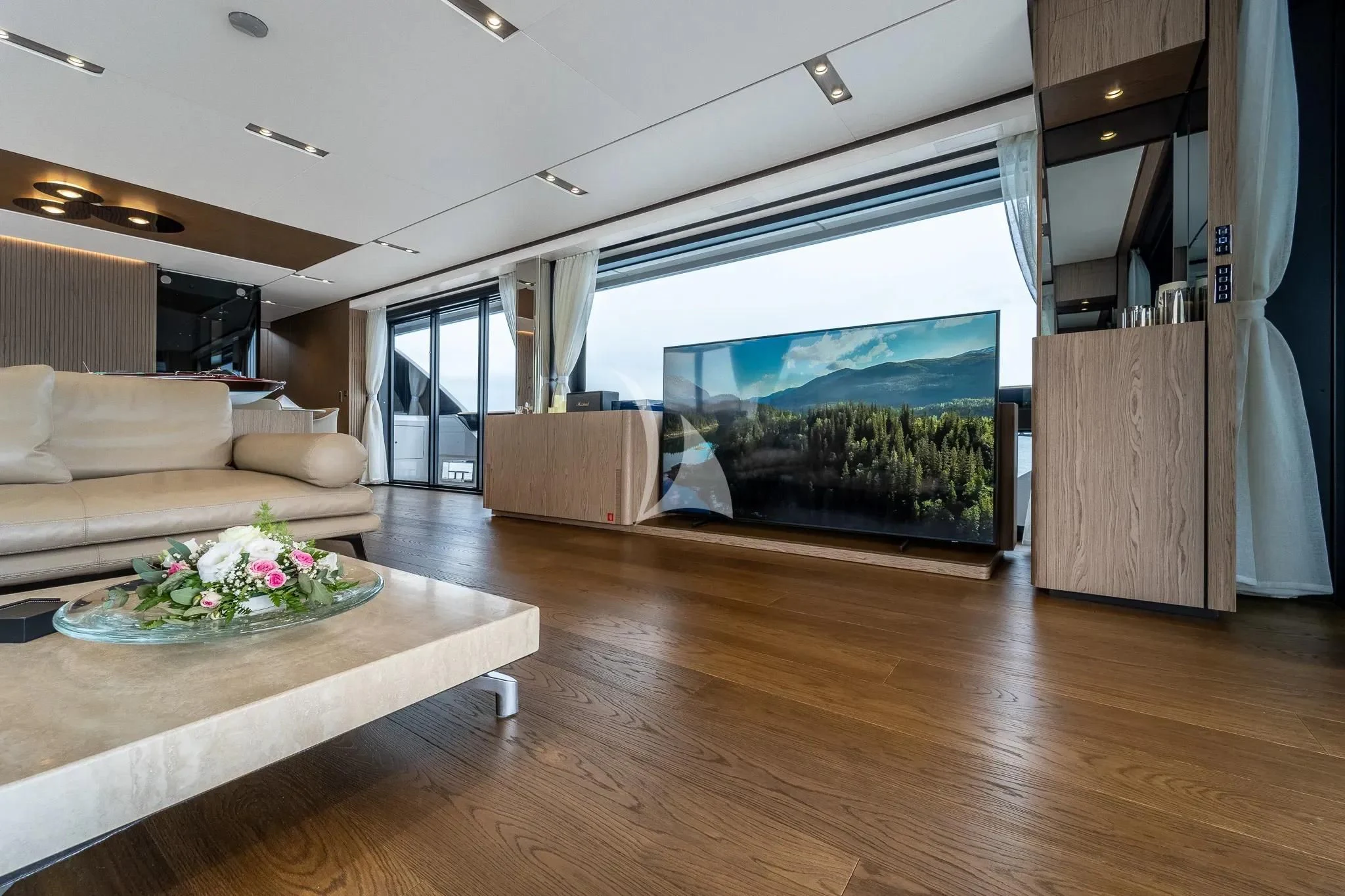 a living room with a large screen aboard DAMARI Yacht for Charter