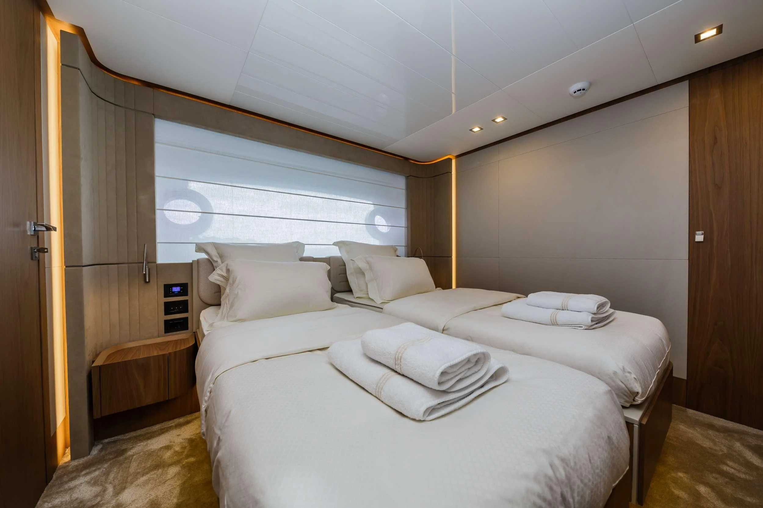 a room with a bed and a window aboard DAMARI Yacht for Charter
