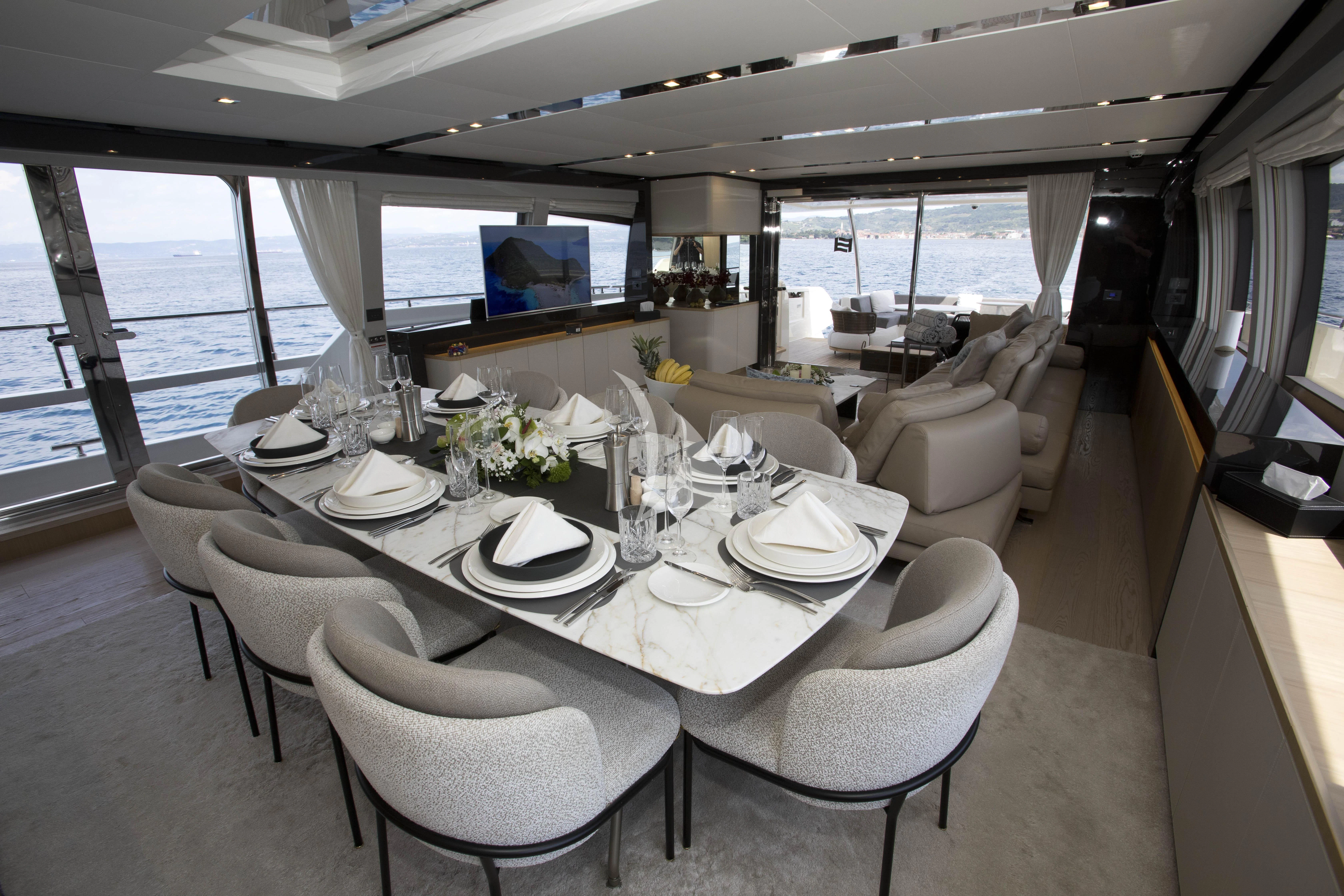 a dining room with a large table aboard DAMARI Yacht for Charter