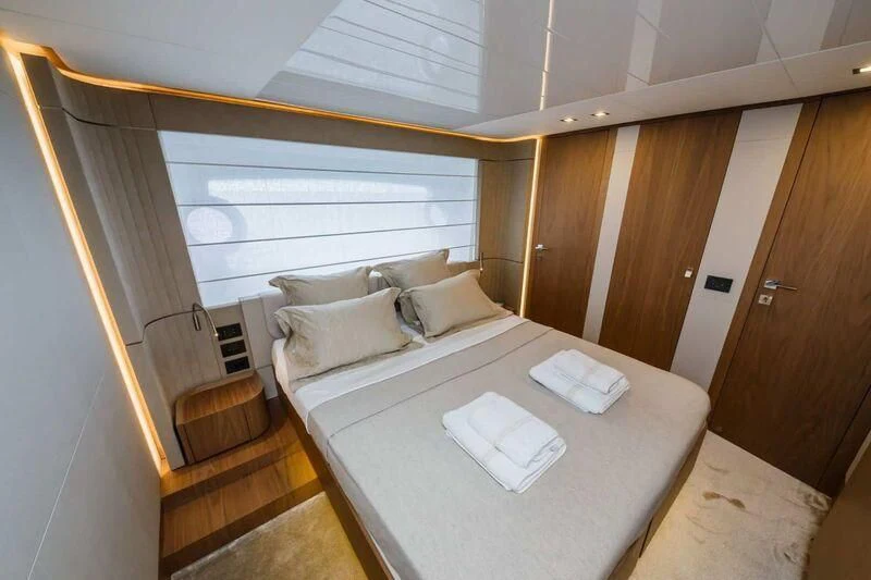 a bed with a table aboard DAMARI Yacht for Charter
