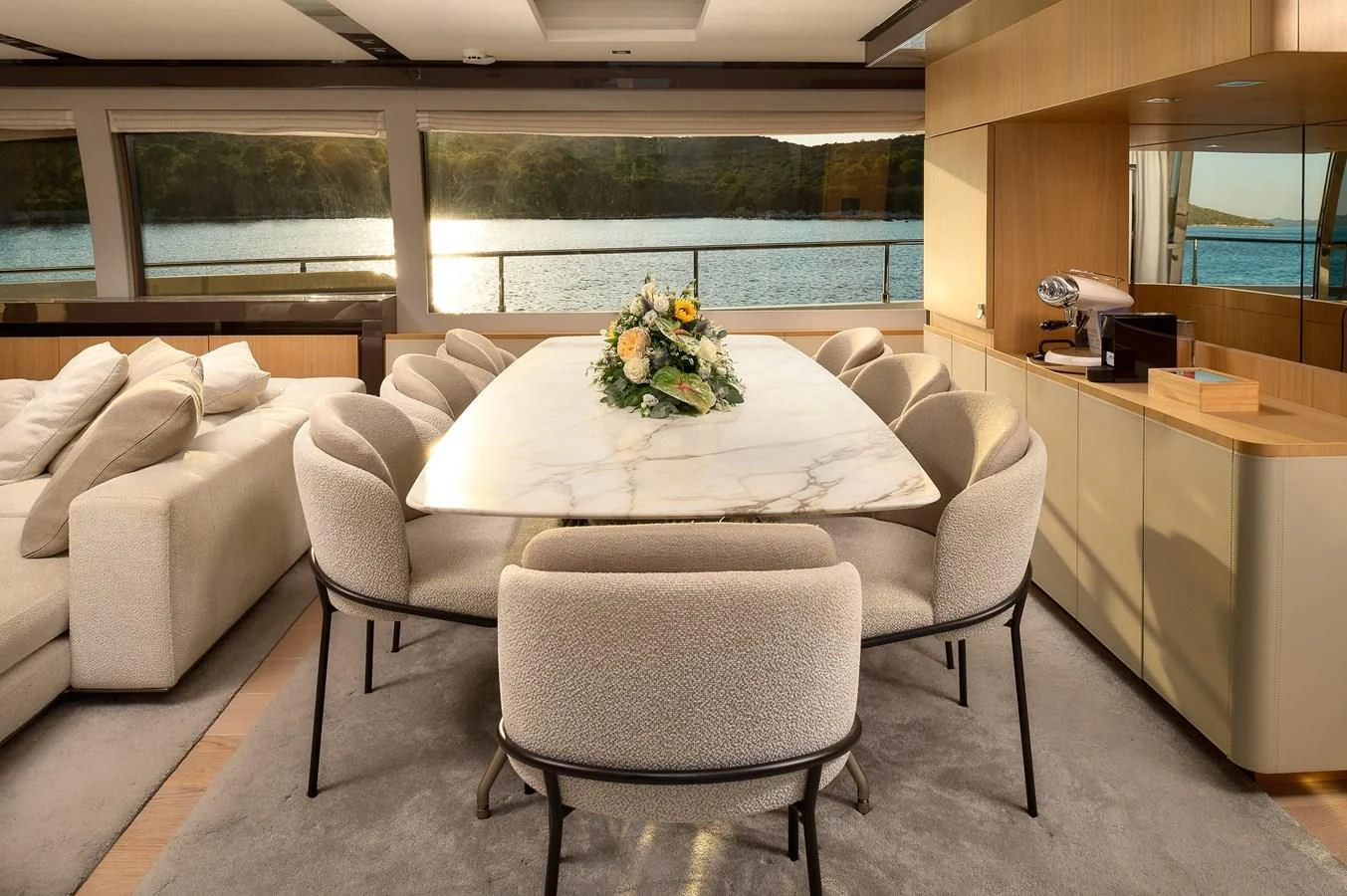 a white living room with a table and chairs aboard DAMARI Yacht for Charter