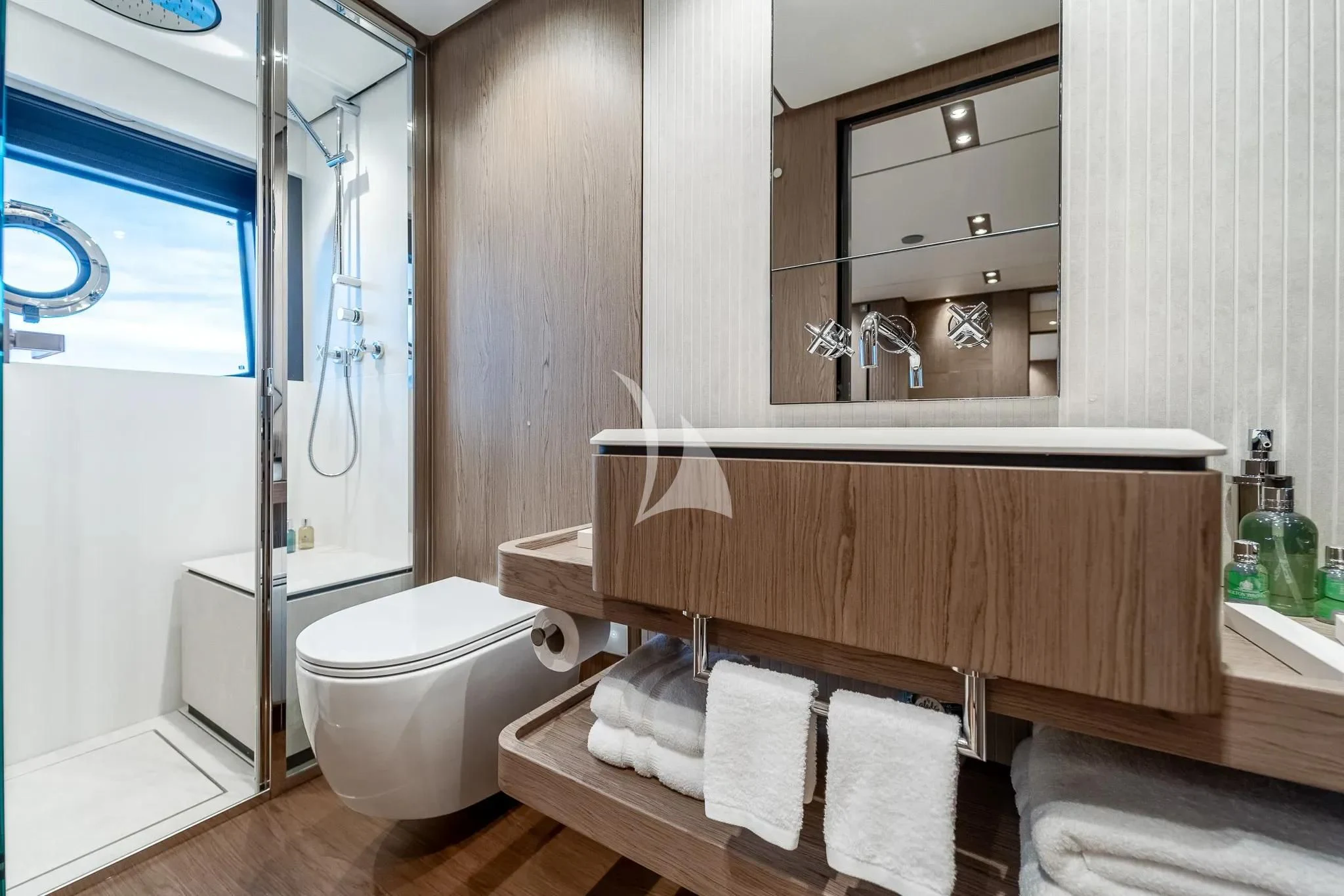 a bathroom with a toilet and a sink aboard DAMARI Yacht for Charter