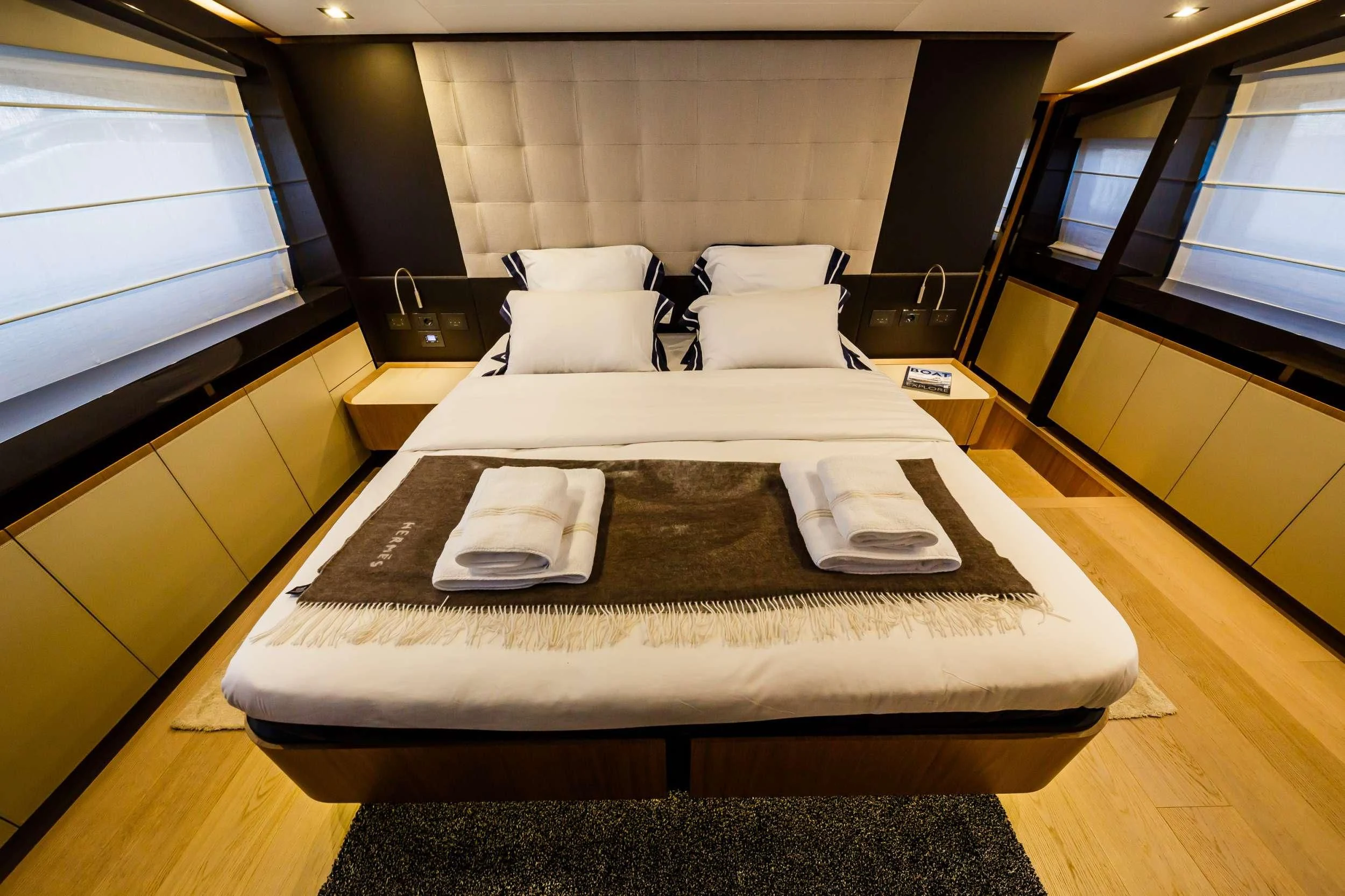 a bed with a tray on it aboard DAMARI Yacht for Charter