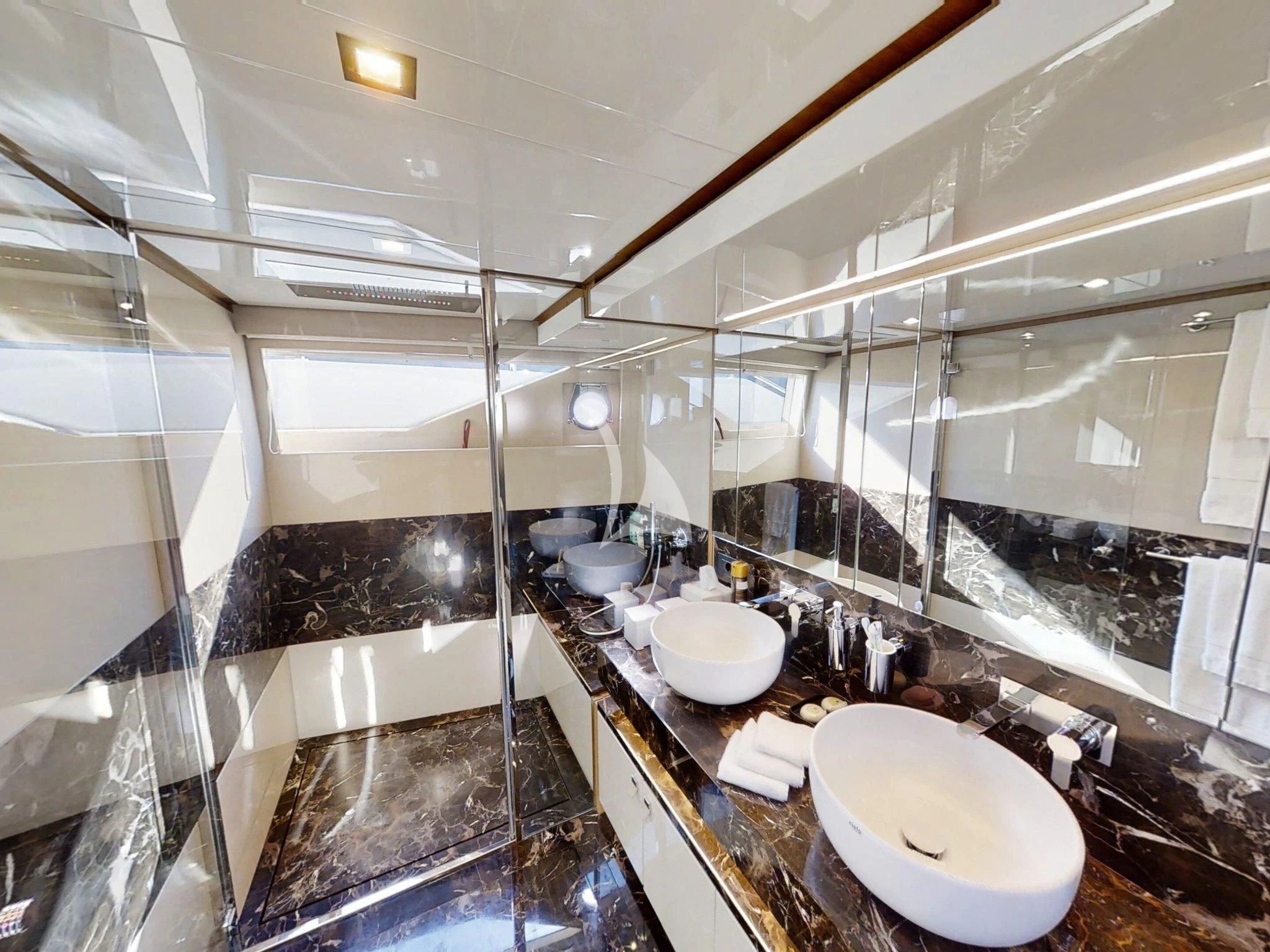 a bathroom with two sinks and a large mirror aboard DAMARI Yacht for Charter