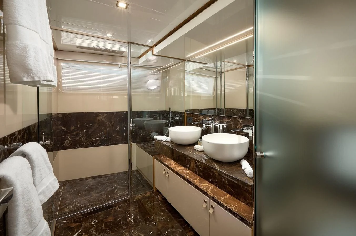 a bathroom with a sink and a bathtub aboard DAMARI Yacht for Charter
