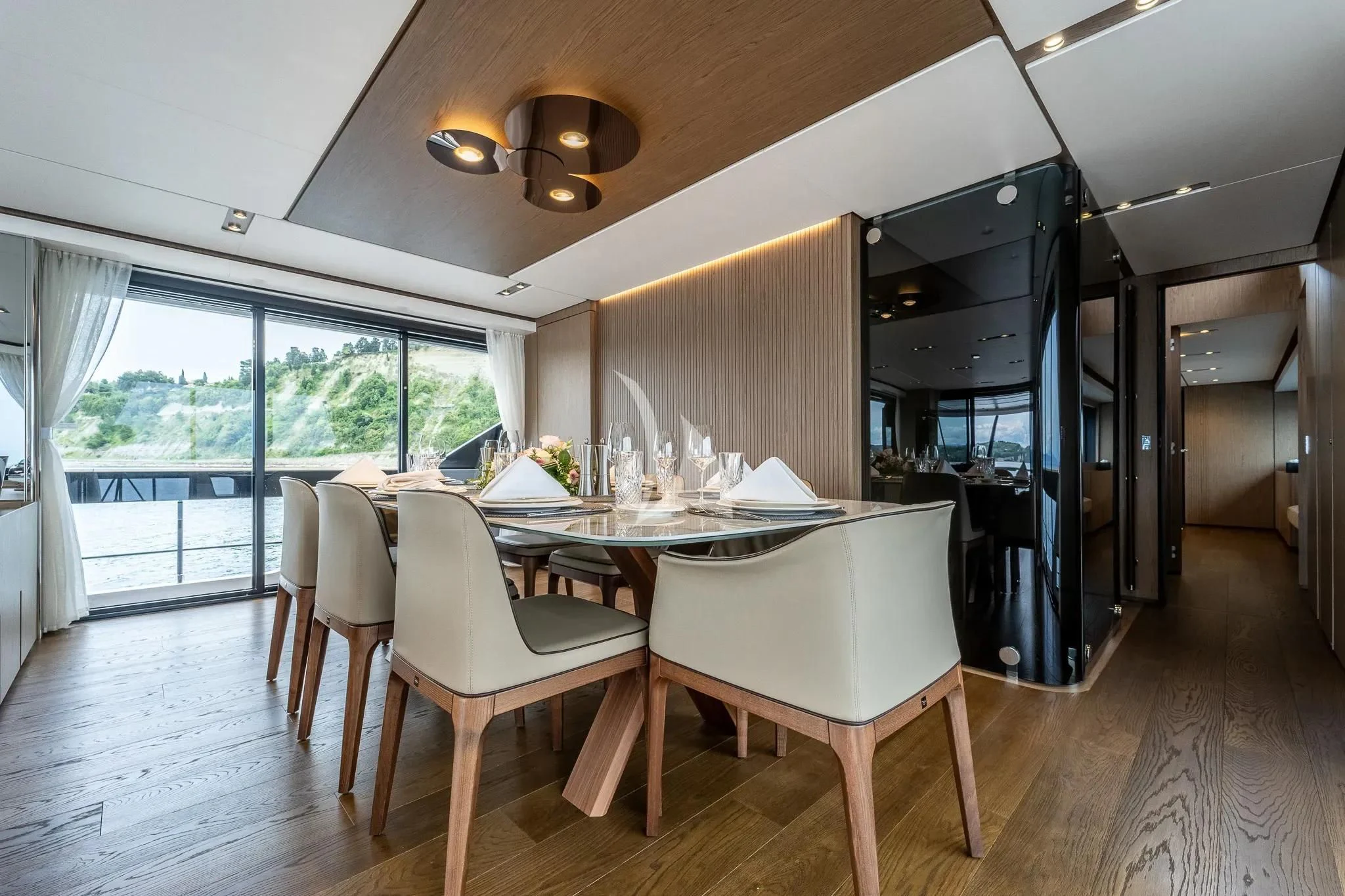 a dining room with a table and chairs aboard DAMARI Yacht for Charter