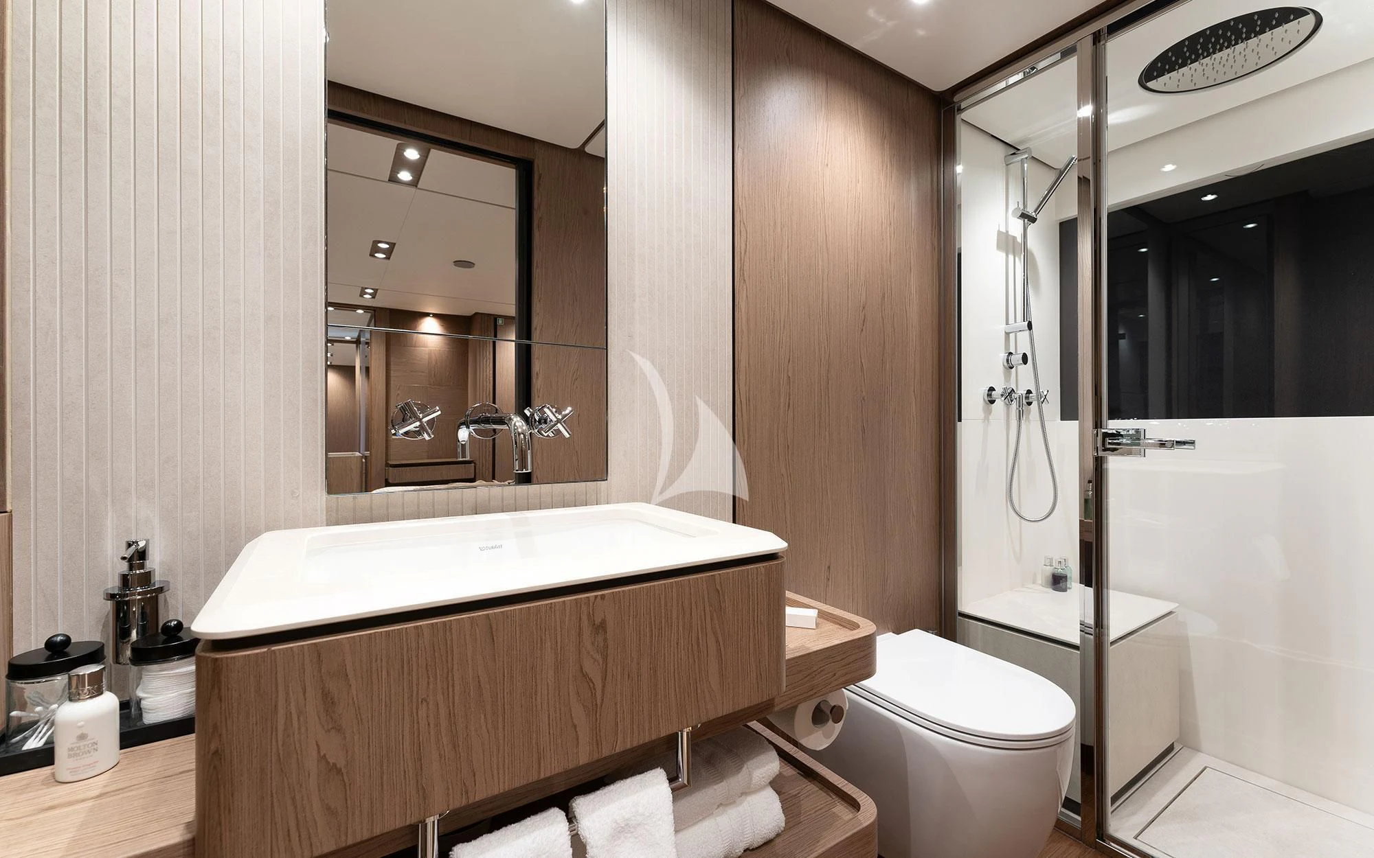 a bathroom with a tub sink and toilet aboard DAMARI Yacht for Charter