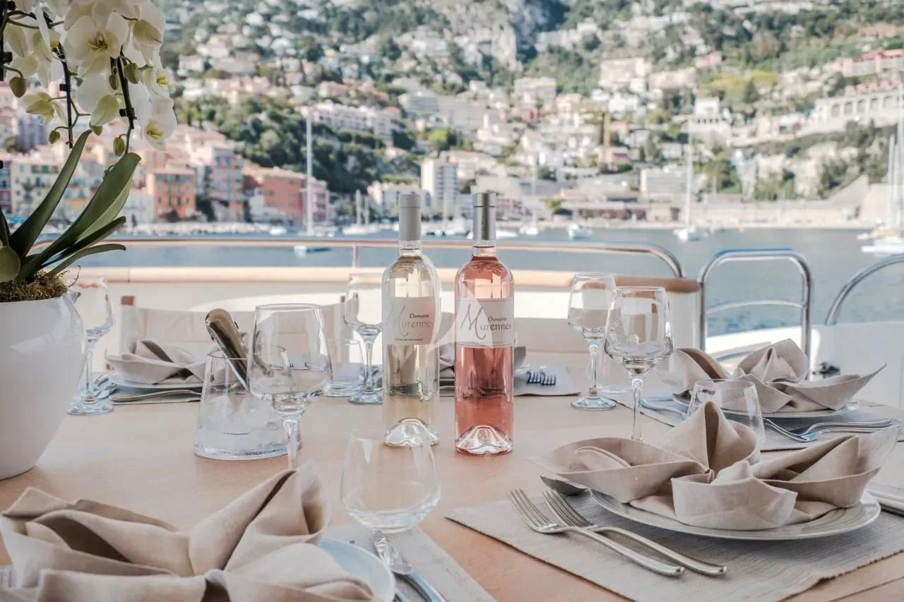 a table with plates and glasses aboard BEIJA FLORE Yacht for Charter