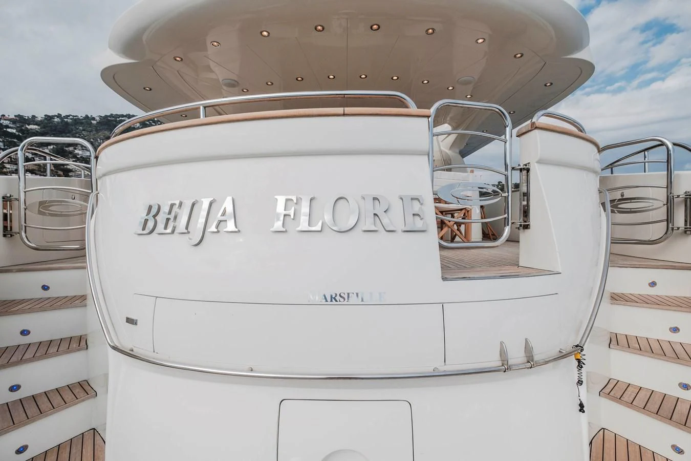 a white car with a door open aboard BEIJA FLORE Yacht for Charter