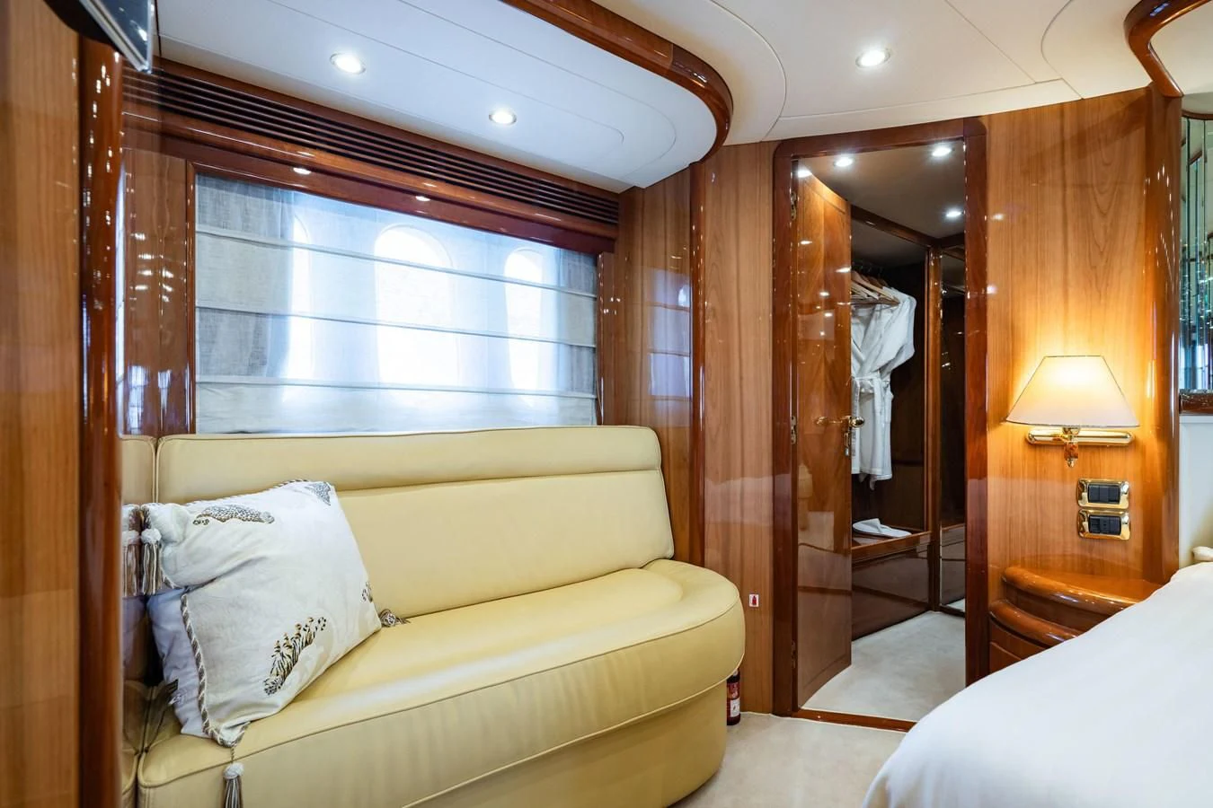 a room with a couch and a mirror aboard BEIJA FLORE Yacht for Charter
