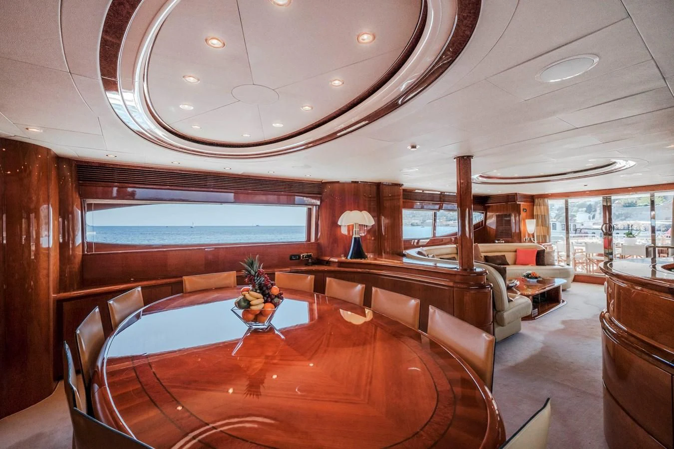 a large living room with a large table and chairs aboard BEIJA FLORE Yacht for Charter